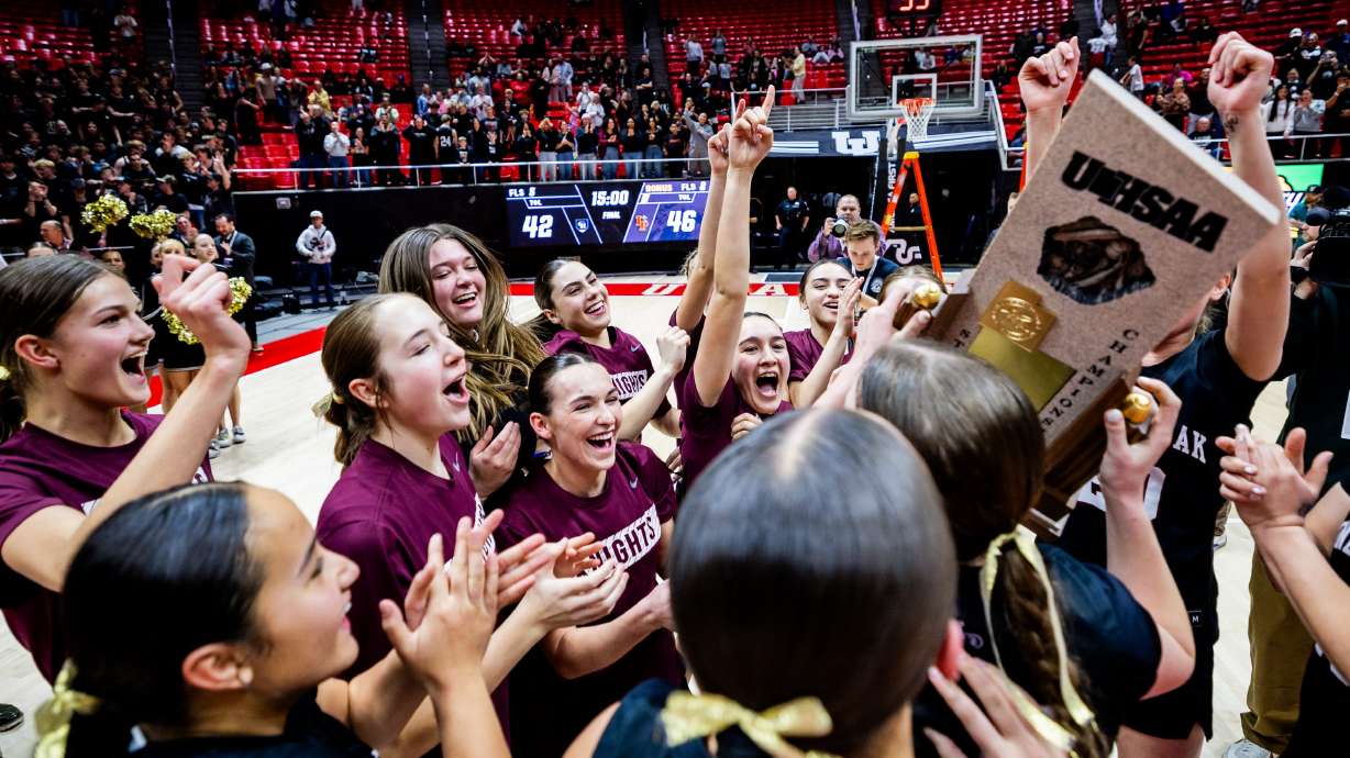 The Lone Peak Knights celebrate after winning 46-42 against the Copper Hills Grizzlies at the 6A girls basketball state championship finals held at the Jon M. Huntsman Center in Salt Lake City on Thursday, Feb. 27, 2025.
