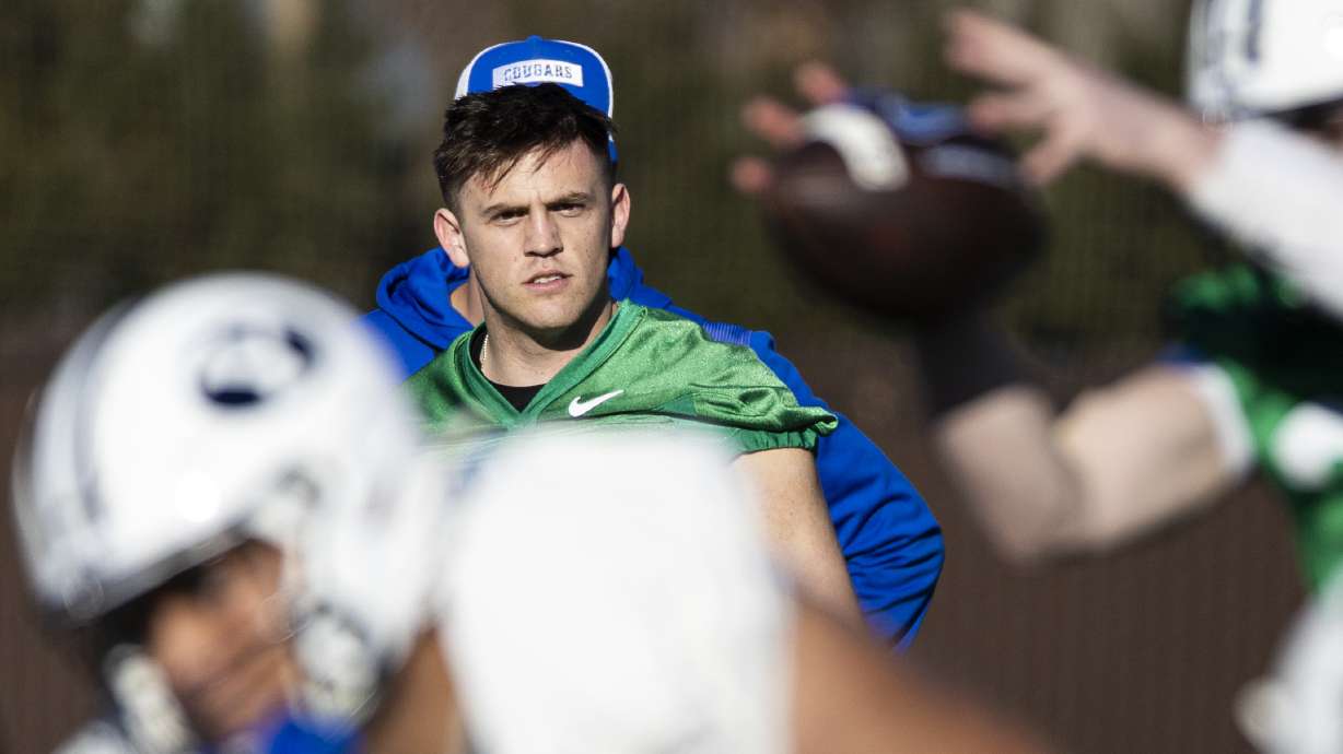 BYU quarterback Jake Retzlaff (12) watches as a play unfolds during the opening day of BYU football spring camp held at the Zions Bank Practice Fields of the Student Athlete Building on the campus of Brigham Young University in Provo on Thursday, Feb. 27, 2025.