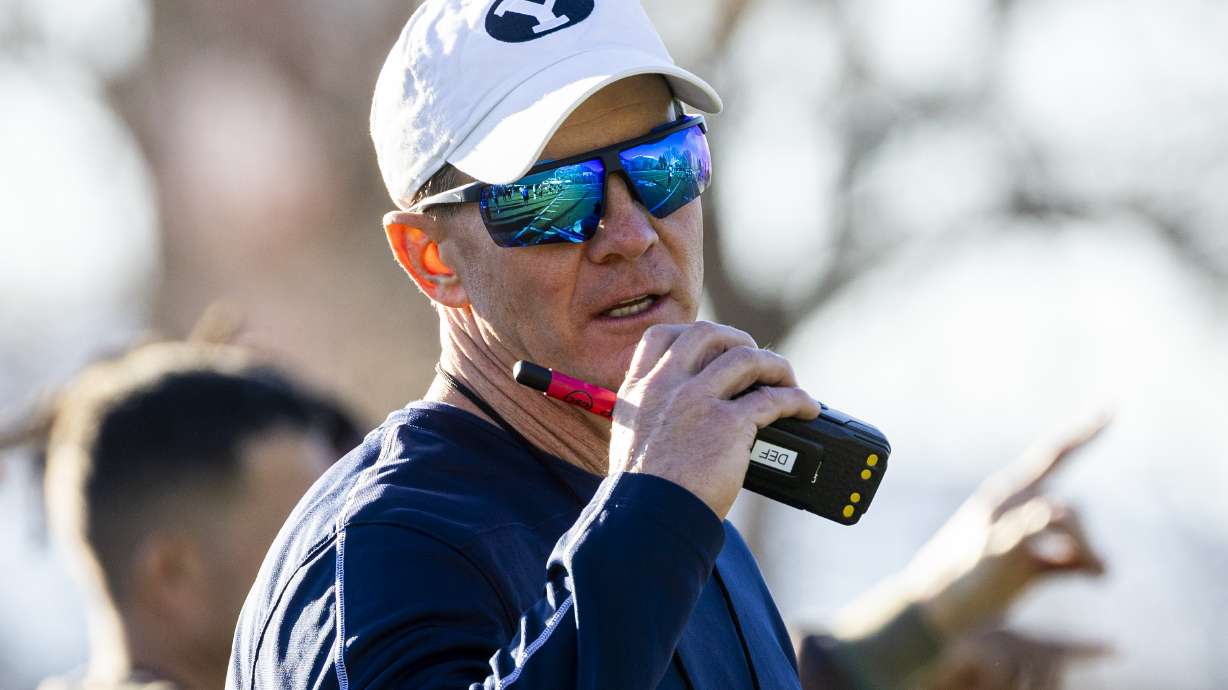 BYU defensive coordinator Jay Hill talks on his handheld radio during the opening day of BYU football spring camp held at the Zions Bank Practice Fields of the Student Athlete Building on the campus of Brigham Young University in Provo on Thursday, Feb. 27, 2025.