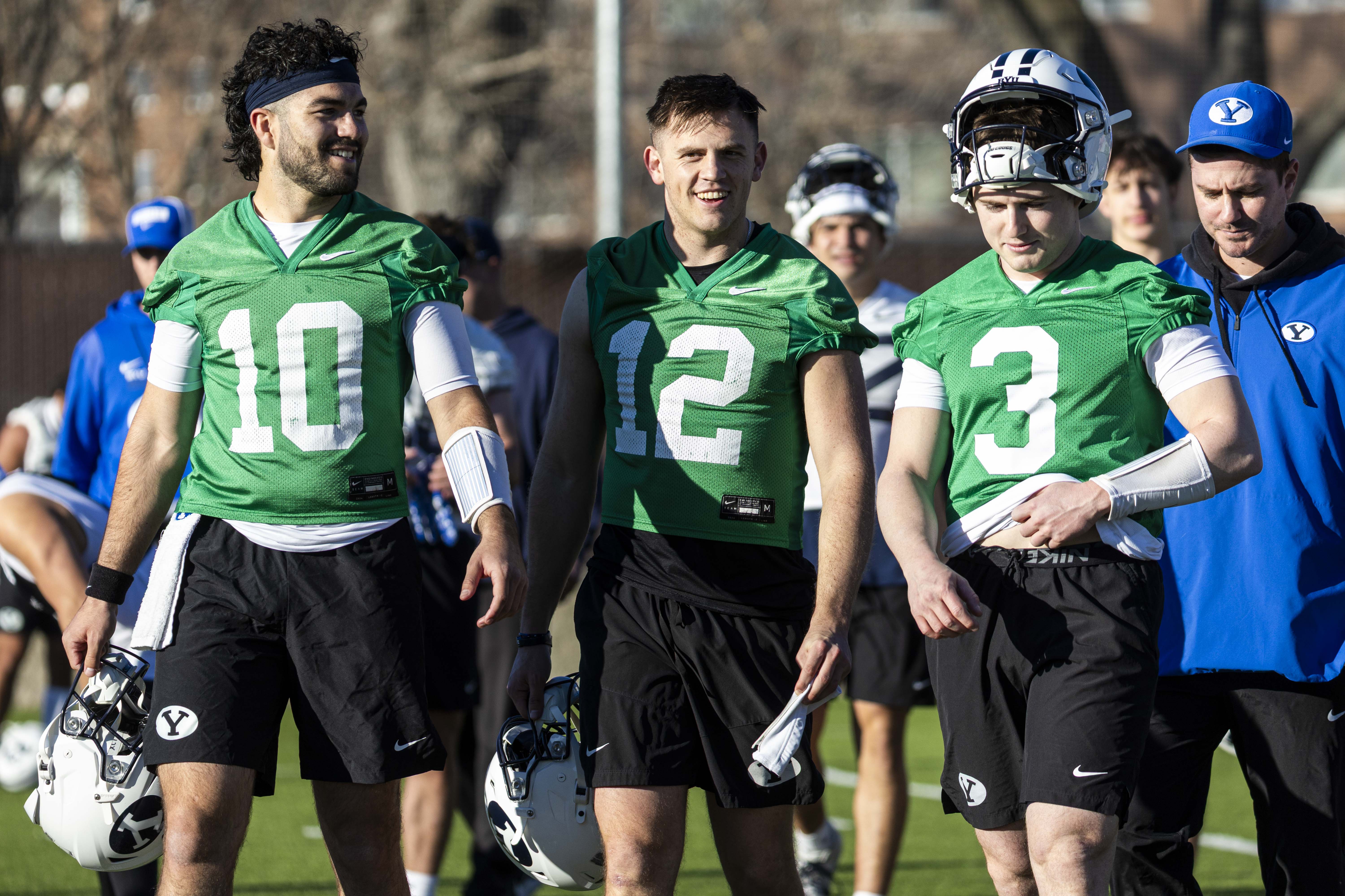 BYU quarterbacks, from left, Treyson Bourguet (10), Jake Retzlaff (12) and McCae Hillstead (3) talk as they walk off the field after the opening day of BYU football spring camp held at the Zions Bank Practice Fields of the Student Athlete Building on the campus of Brigham Young University in Provo on Thursday, Feb. 27, 2025.