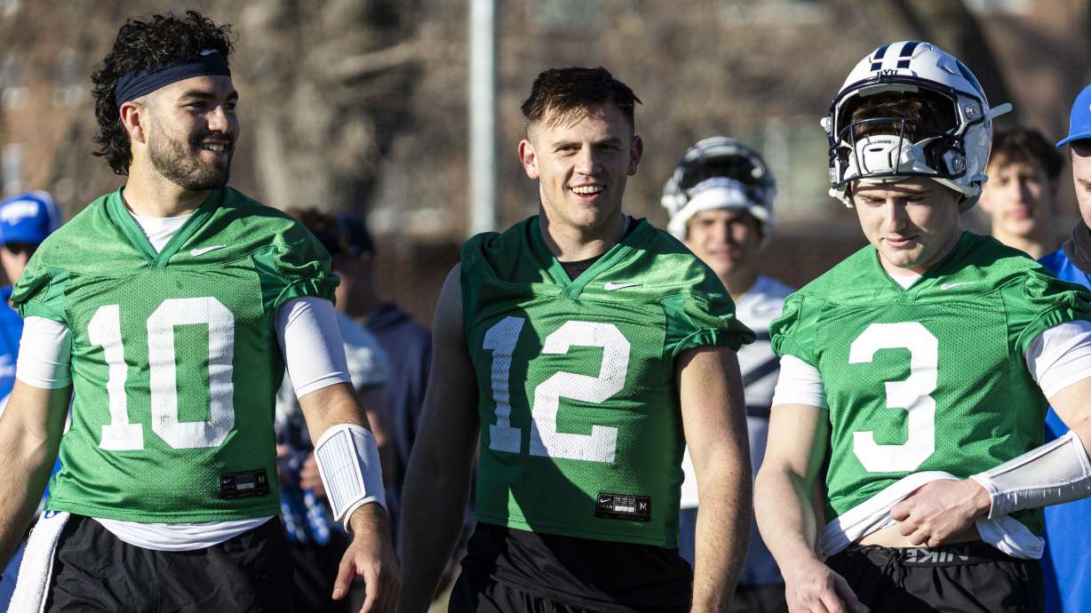 BYU quarterbacks, from left, Treyson Bourguet (10), Jake Retzlaff (12) and McCae Hillstead (3) talk as they walk off the field after the opening day of BYU football spring camp held at the Zions Bank Practice Fields of the Student Athlete Building on the campus of Brigham Young University in Provo on Thursday, Feb. 27, 2025.