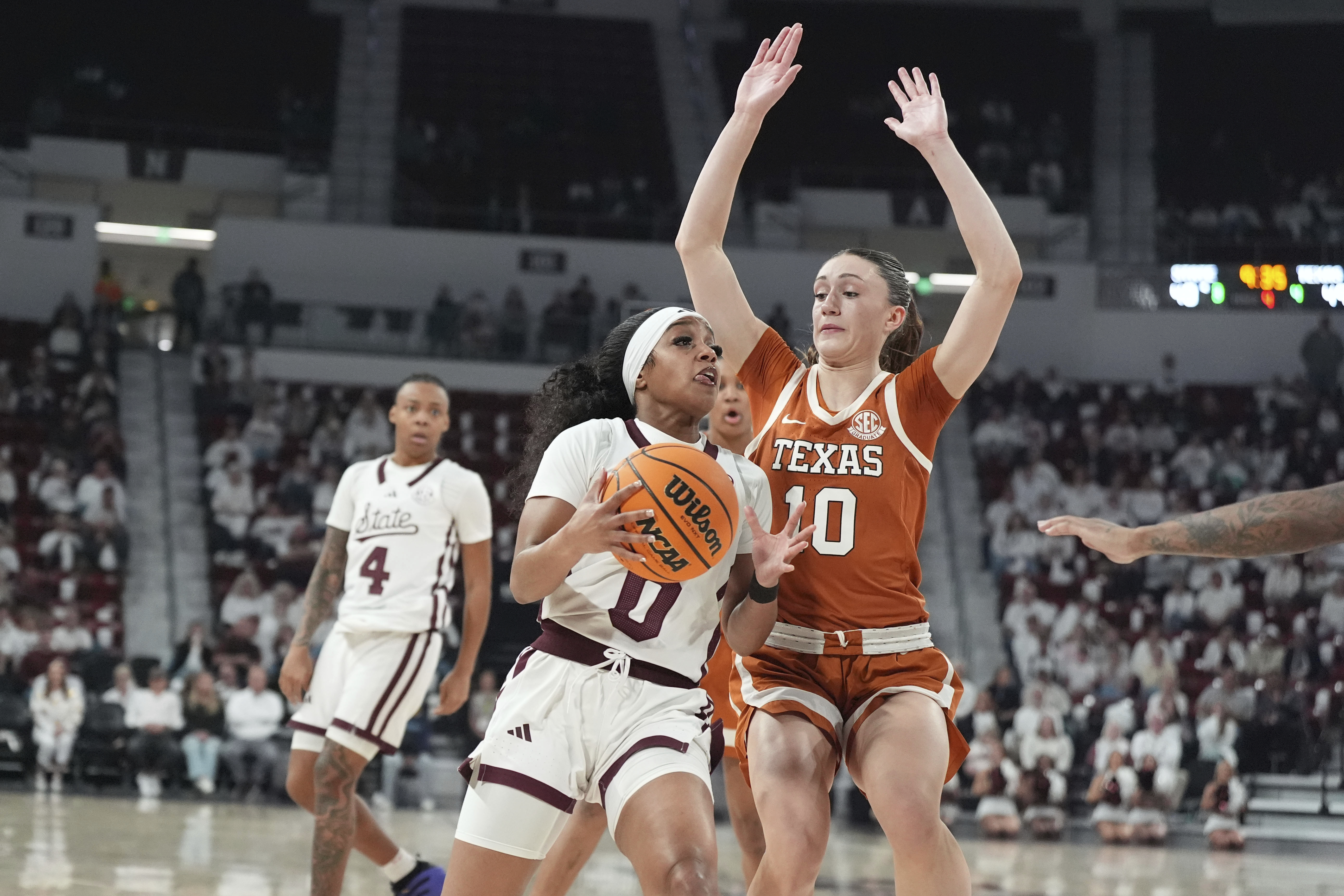 Mississippi State guard Denim DeShields (0) is guarded by Texas guard Shay Holle (10) during the second half of an NCAA college basketball game, Thursday, Feb. 27, 2025, in Starkville, Miss. 