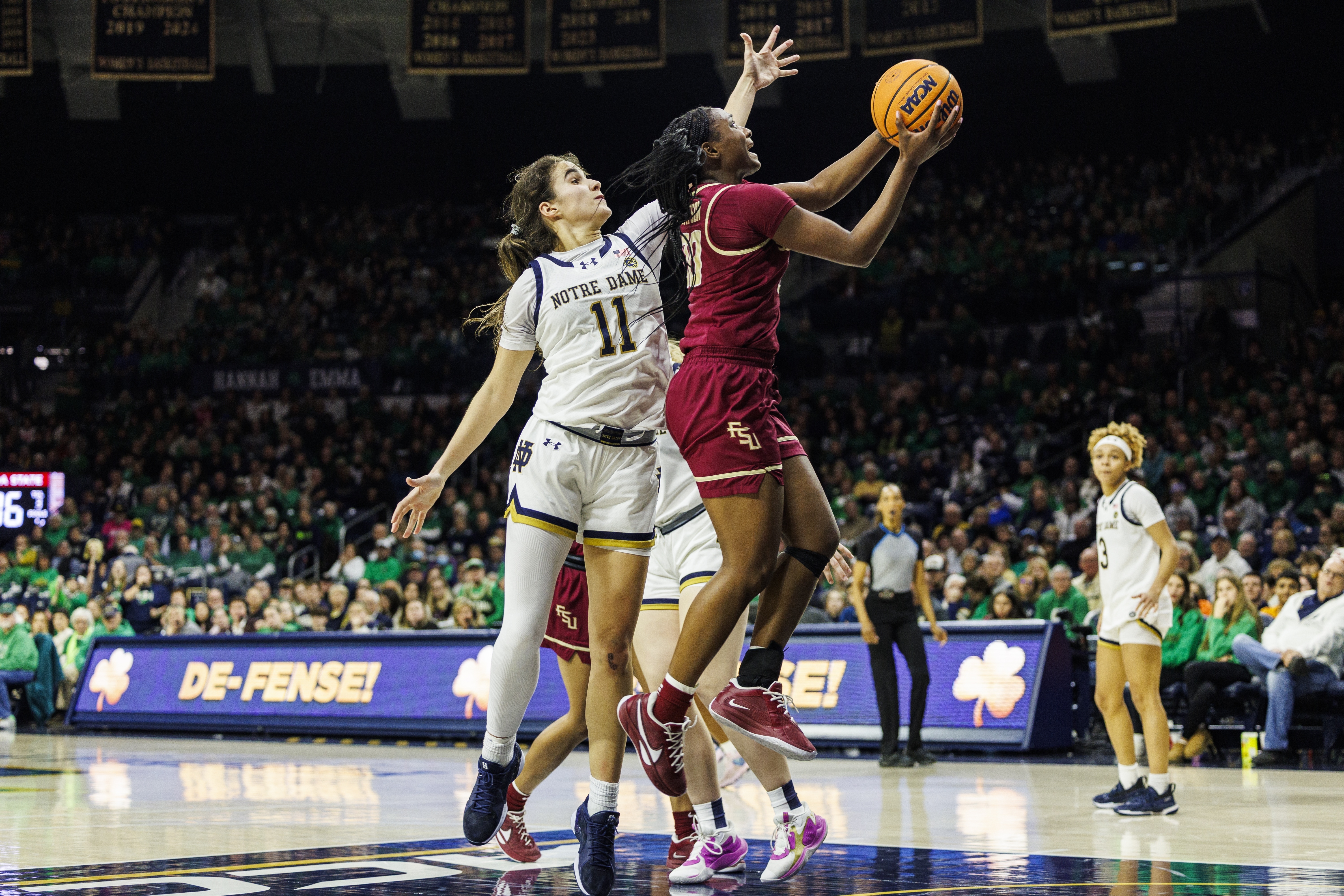 Florida State guard Ta'Niya Latson (00) around over Notre Dame guard Sonia Citron (11) during the second half of an NCAA college basketball game Thursday, Feb. 27, 2025, in South Bend, Ind. 