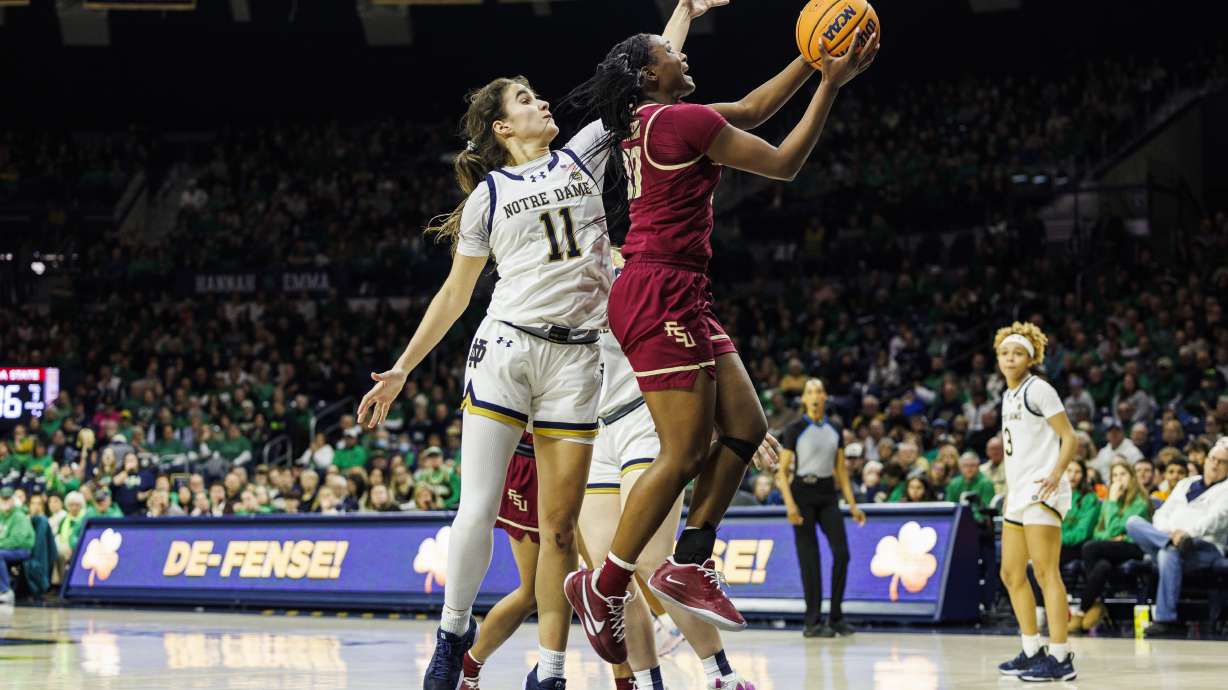 Florida State guard Ta'Niya Latson (00) around over Notre Dame guard Sonia Citron (11) during the second half of an NCAA college basketball game Thursday, Feb. 27, 2025, in South Bend, Ind.