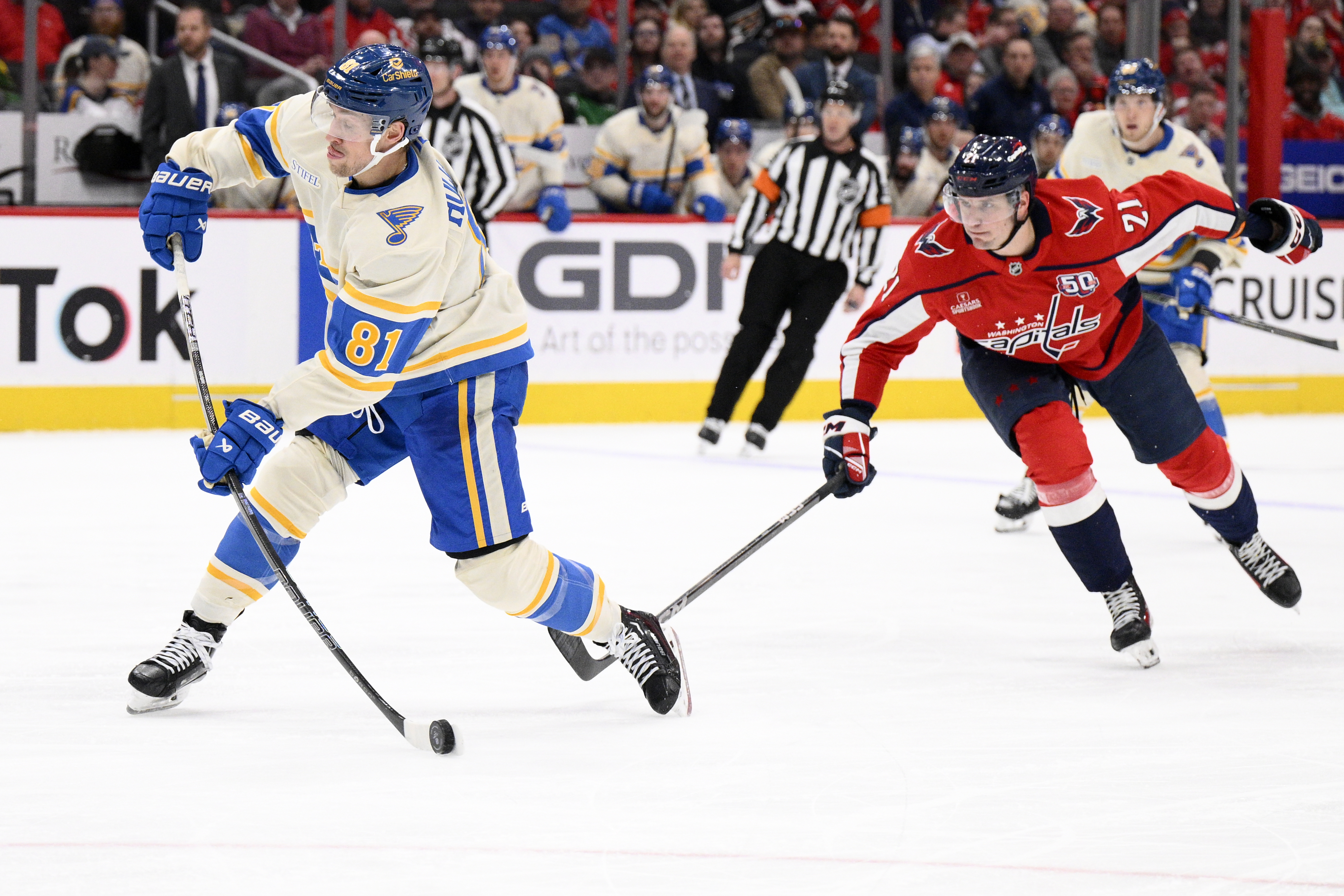 St. Louis Blues center Dylan Holloway (81) shoots the puck past Washington Capitals center Aliaksei Protas (21) during the second period of an NHL hockey game, Thursday, Feb. 27, 2025, in Washington.
