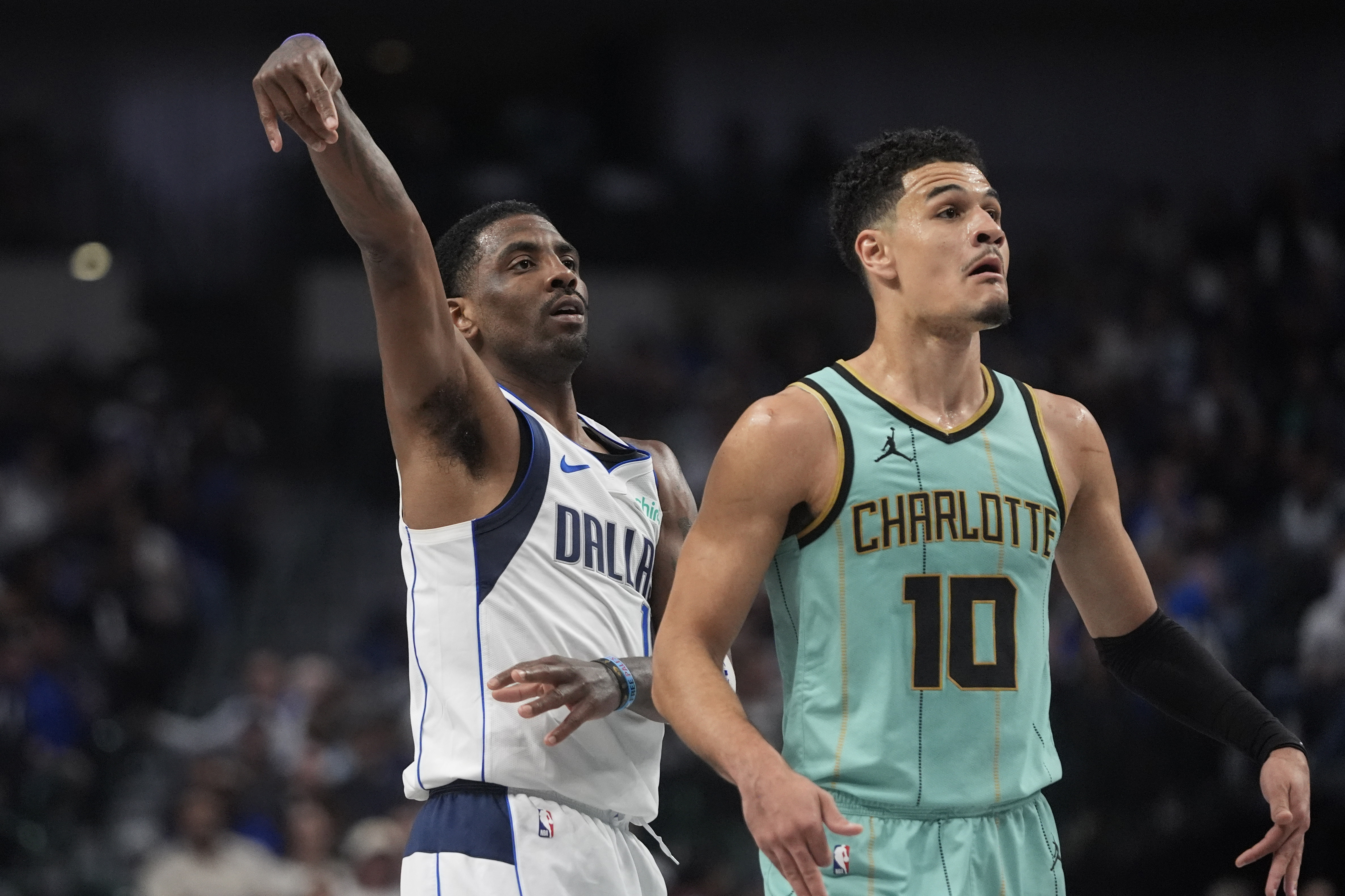 Dallas Mavericks guard Kyrie Irving (11) watches his shot against Charlotte Hornets guard Josh Green (10) during the first half of an NBA basketball game in Dallas, Thursday, Feb. 27, 2025. 