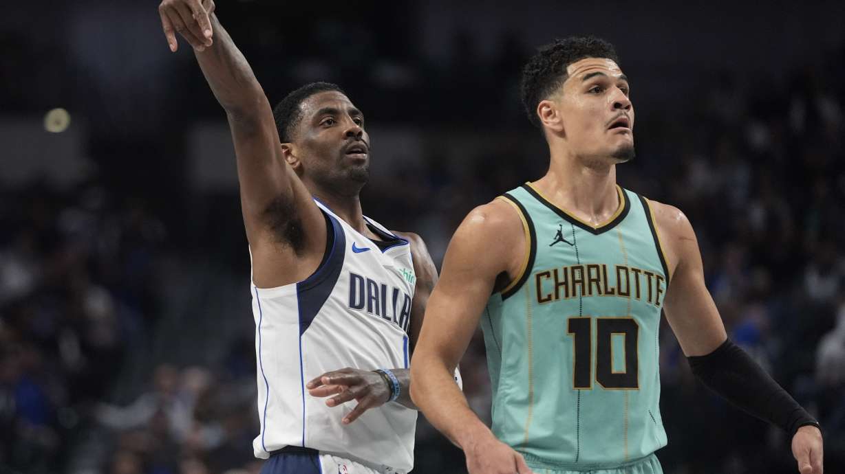 Dallas Mavericks guard Kyrie Irving (11) watches his shot against Charlotte Hornets guard Josh Green (10) during the first half of an NBA basketball game in Dallas, Thursday, Feb. 27, 2025.