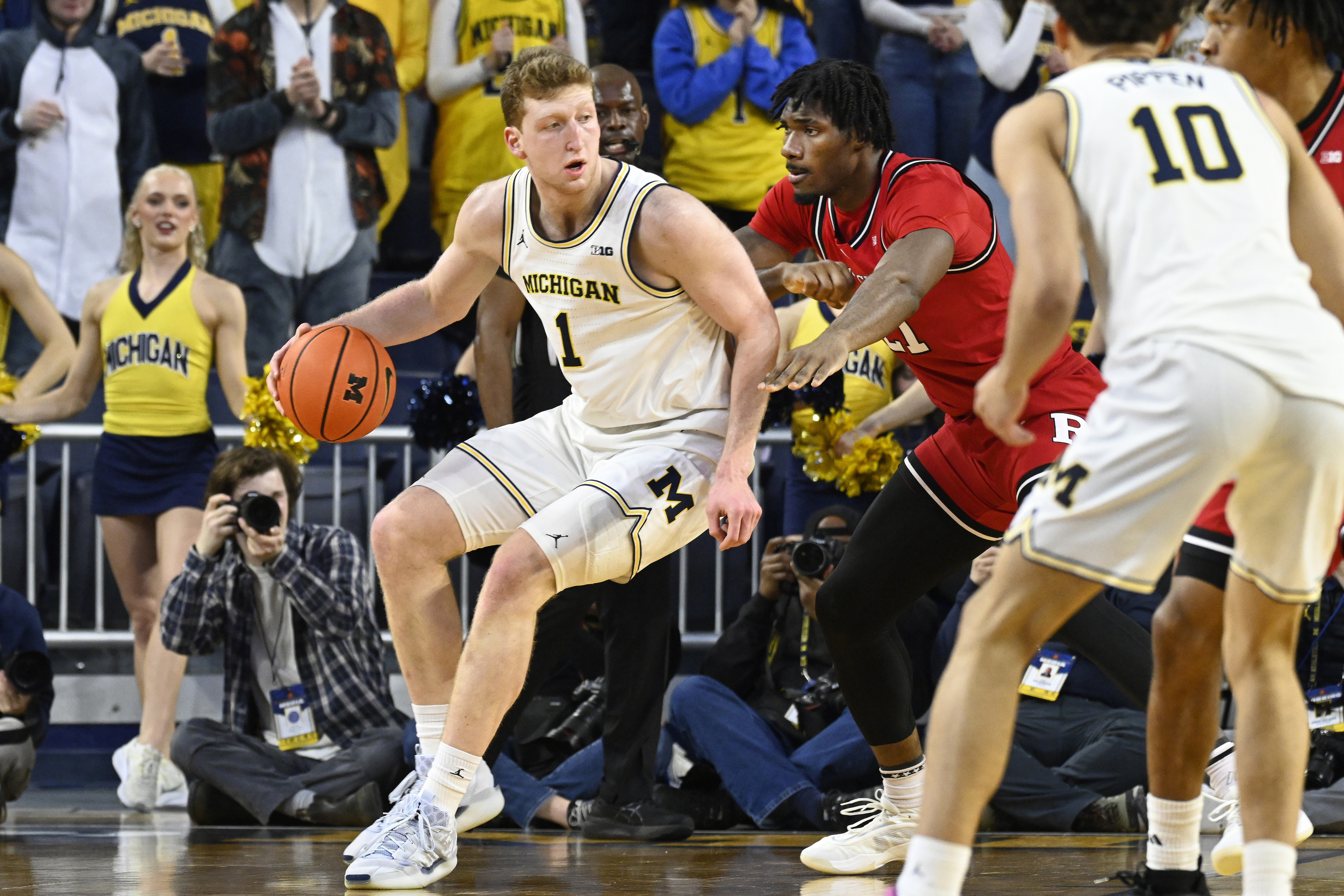 Michigan forward Danny Wolf, left, tries to get past Rutgers center Emmanuel Ogbole during the first half of an NCAA college basketball game, Thursday, Feb. 27, 2025, in Ann Arbor, Mich. 