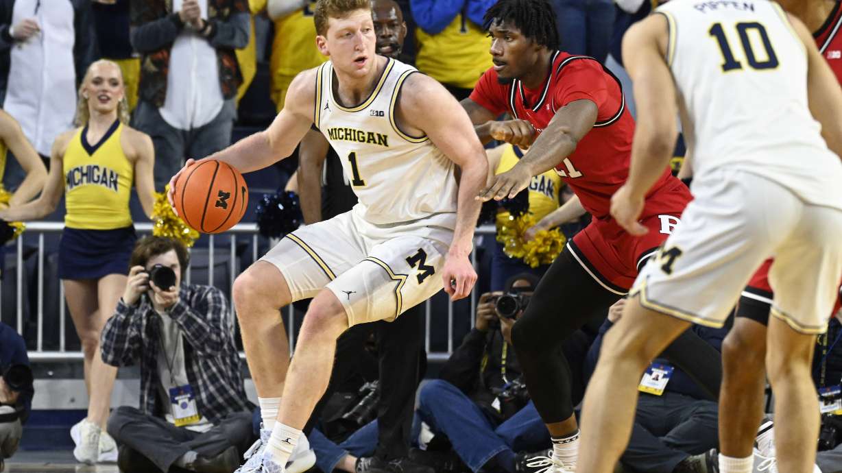 Michigan forward Danny Wolf, left, tries to get past Rutgers center Emmanuel Ogbole during the first half of an NCAA college basketball game, Thursday, Feb. 27, 2025, in Ann Arbor, Mich.