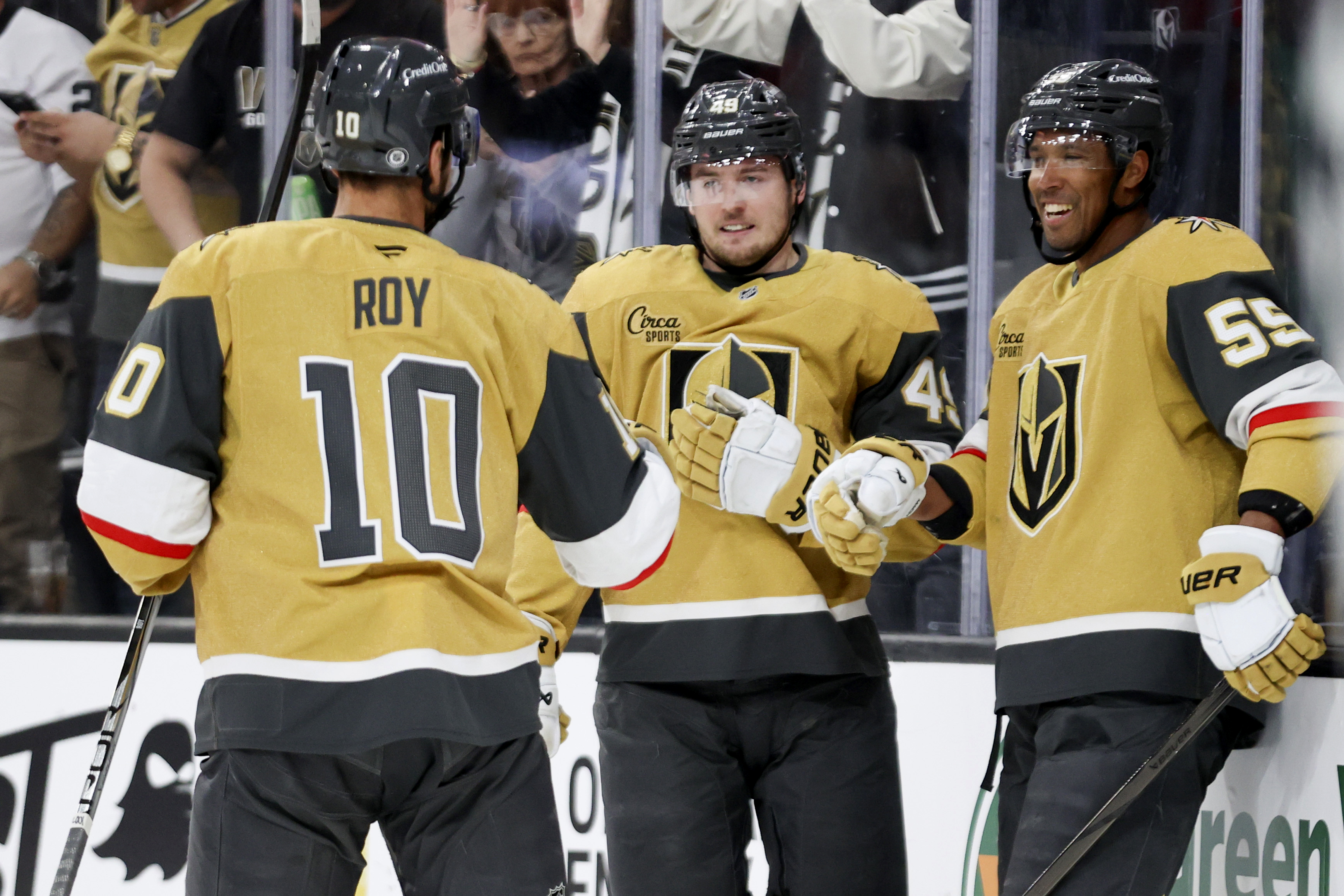 Vegas Golden Knights centers Nicolas Roy (10) and Ivan Barbashev (49) celebrate with right wing Keegan Kolesar (55) after Kolesar's goal during the second period of an NHL hockey game against the Chicago Blackhawks Thursday, Feb. 27, 2025, in Las Vegas.