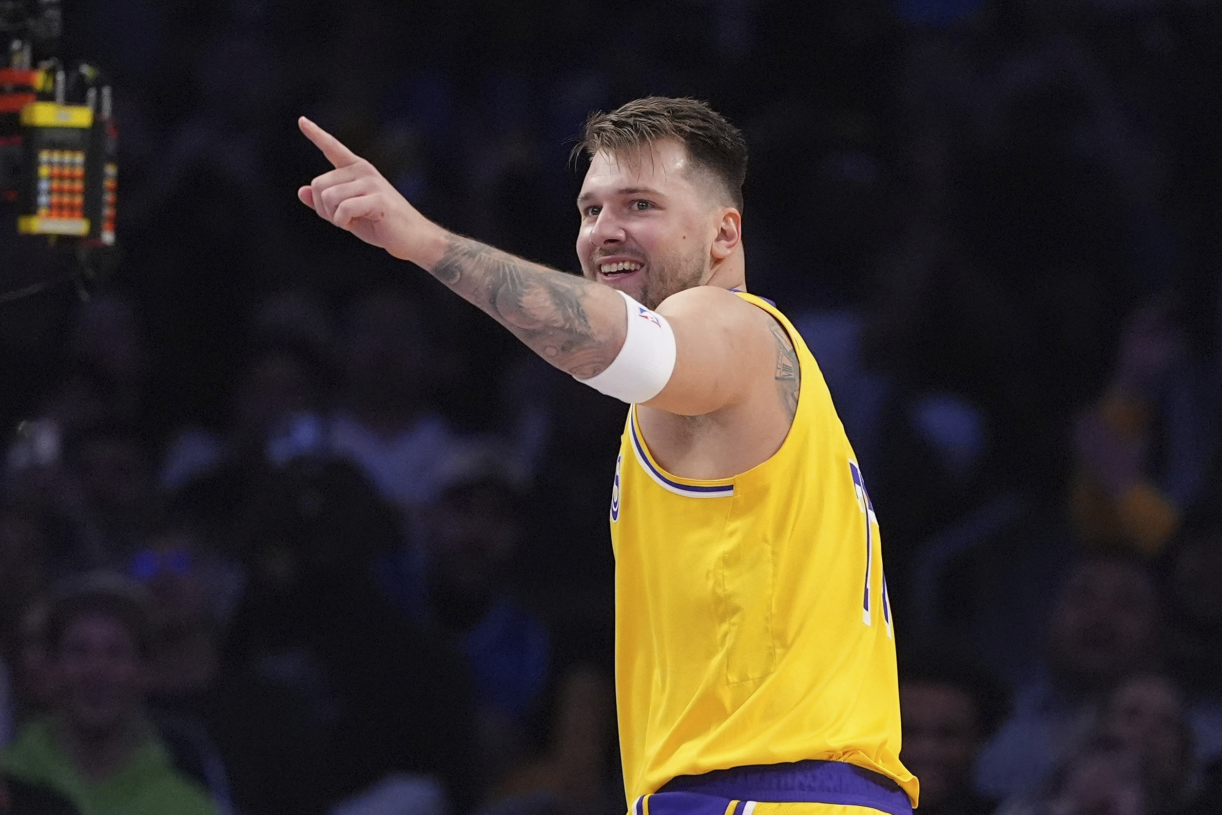 Los Angeles Lakers guard Luka Doncic gestures toward forward LeBron James after he scored with an assist by James during the first half of an NBA basketball game against the Minnesota Timberwolves, Thursday, Feb. 27, 2025, in Los Angeles.