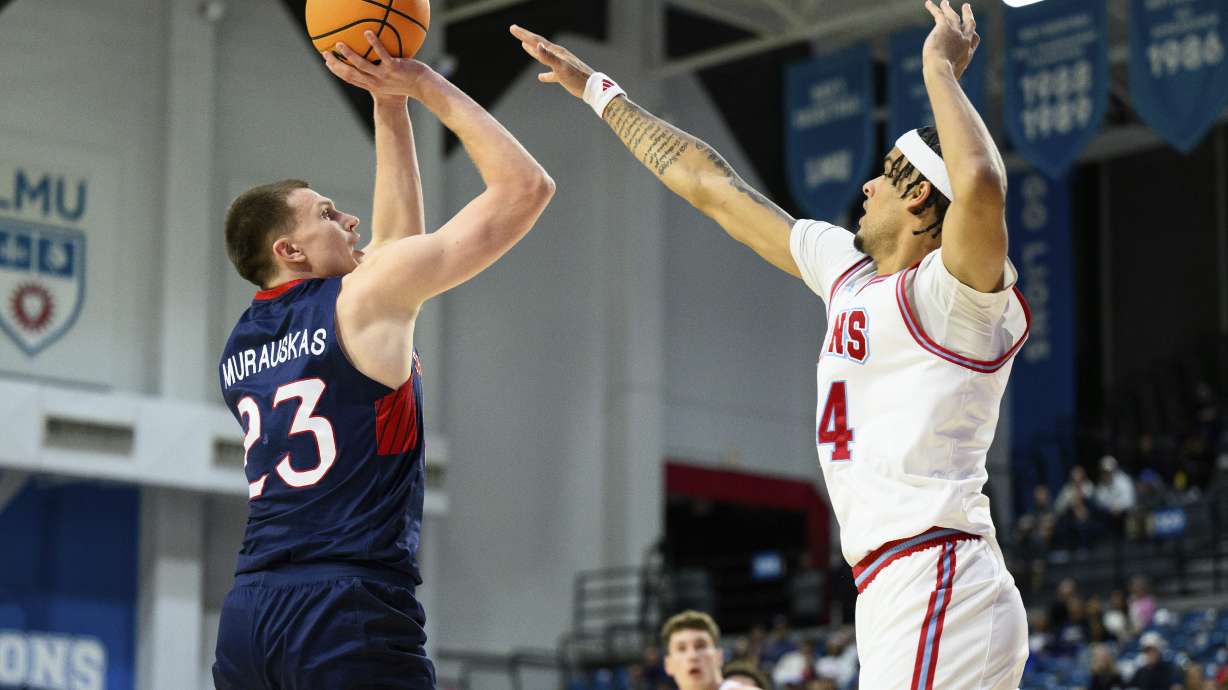 Saint Mary's forward Paulius Murauskas (23) shoots while Loyola Marymount forward Jevon Porter defends during the first half of an NCAA college basketball game Thursday, Feb. 27, 2025, in Los Angeles.