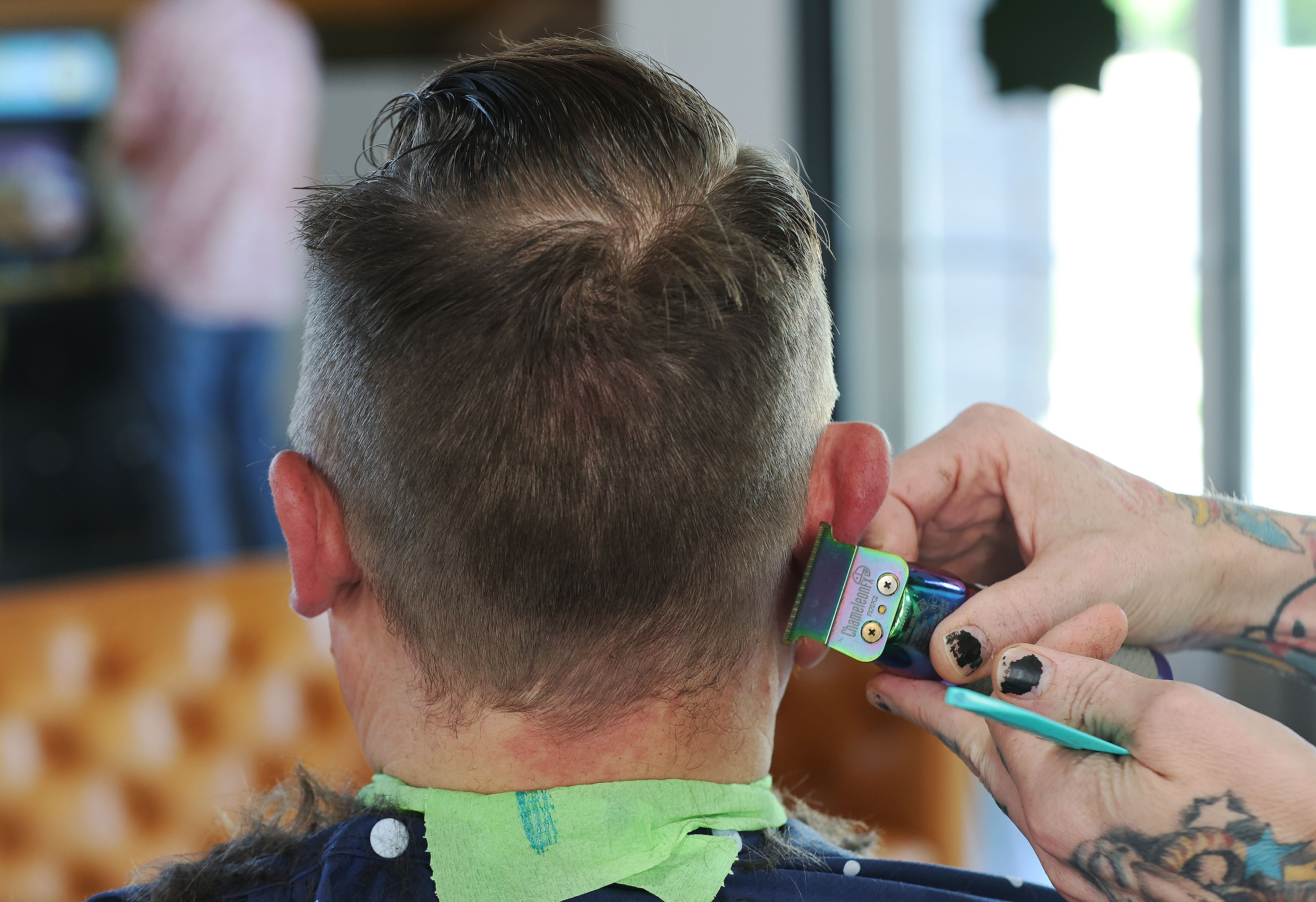 Jeremy Grimshaw gets a haircut at Salt Lake Barber Company in Salt Lake City on July 25, 2023.