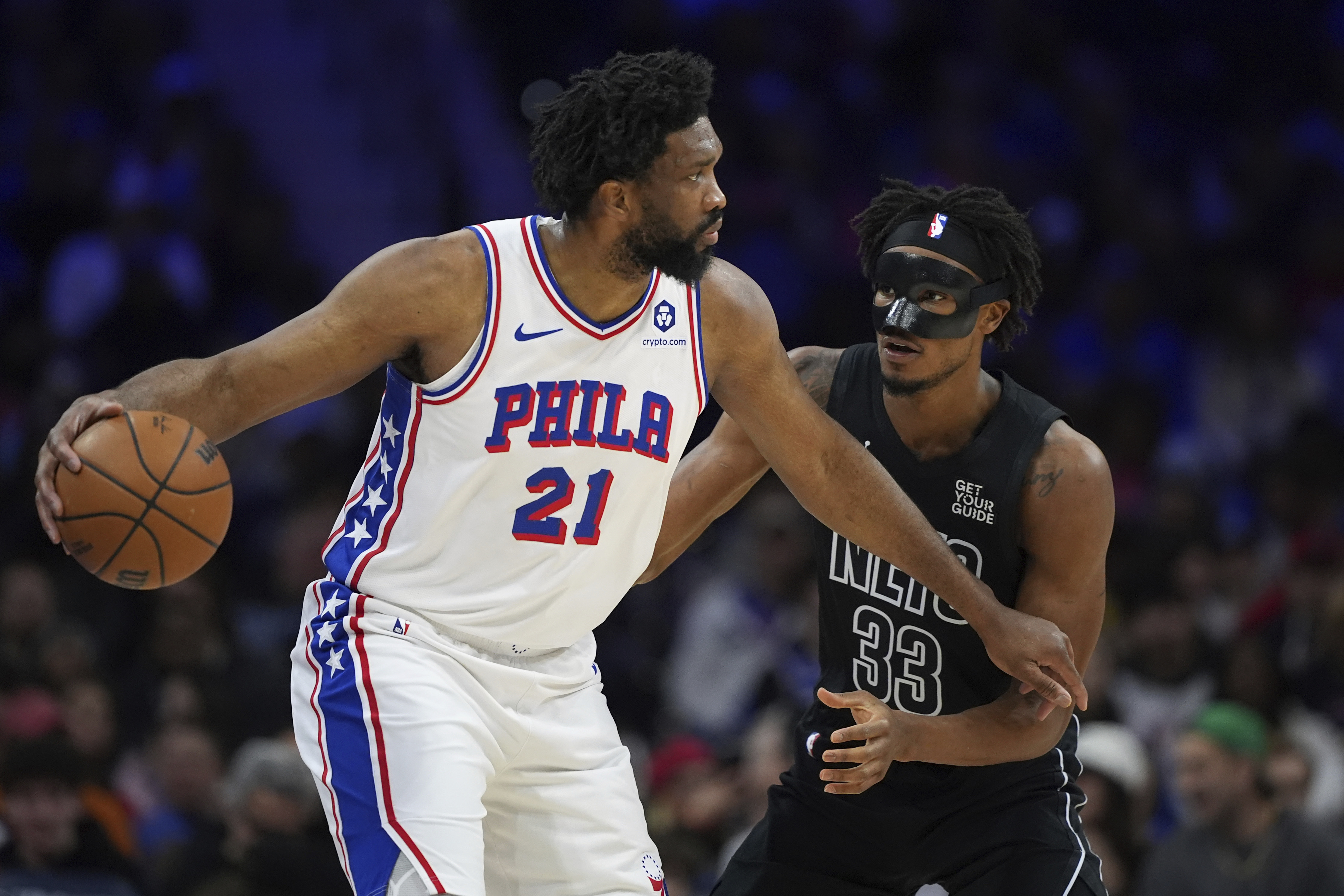 Philadelphia 76ers' Joel Embiid, left, tries to get past Brooklyn Nets' Nic Claxton during the first half of an NBA basketball game, Saturday, Feb. 22, 2025, in Philadelphia. 