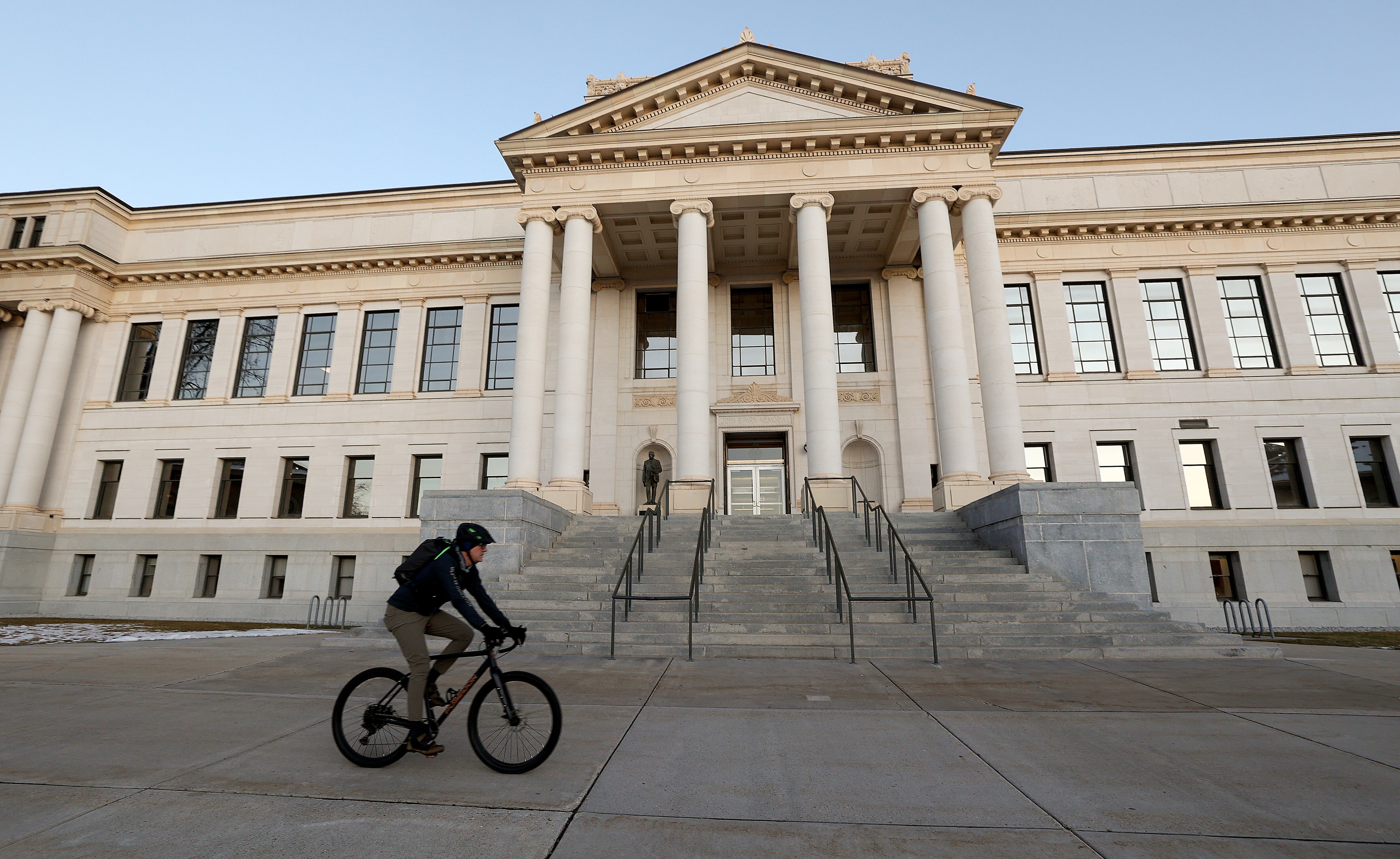 A cyclist rides through Presidents' Circle at the University of Utah in Salt Lake City on Jan. 7.