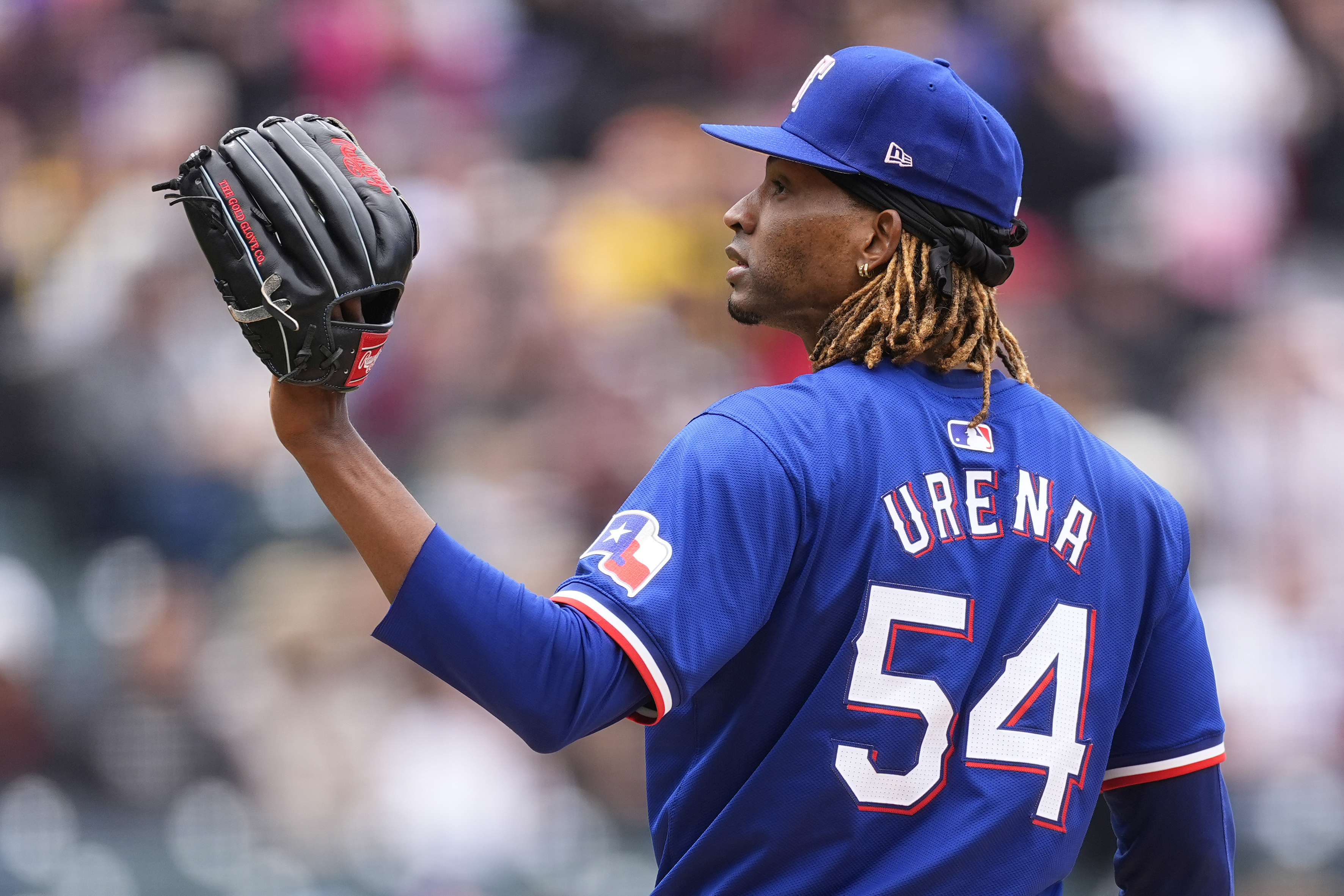 FILE - Texas Rangers pitcher José Ureña calls for a new ball after giving up a two-run home run to Colorado Rockies' Ezequiel Tovar in the first inning of a baseball game, May 12, 2024, in Denver. 