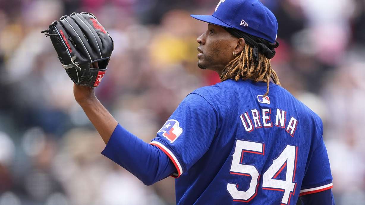 FILE - Texas Rangers pitcher José Ureña calls for a new ball after giving up a two-run home run to Colorado Rockies' Ezequiel Tovar in the first inning of a baseball game, May 12, 2024, in Denver.