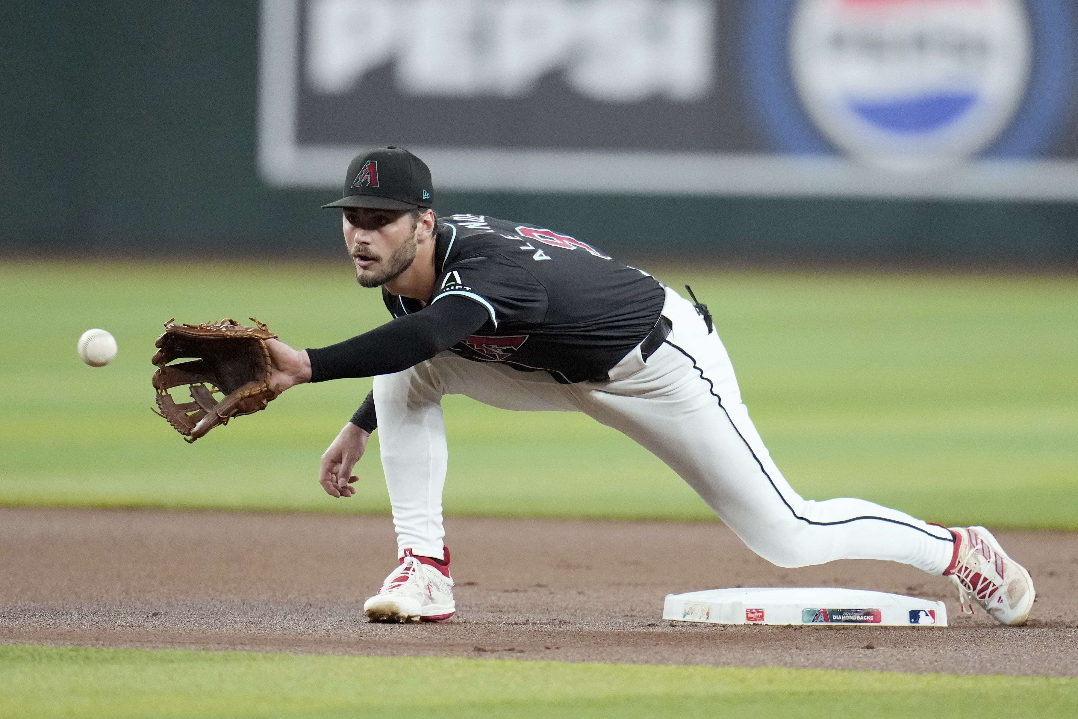 FILE - Arizona Diamondbacks second baseman Blaze Alexander warms up prior to a baseball game against the Colorado Rockies, Wednesday, Aug. 14, 2024, in Phoenix. 