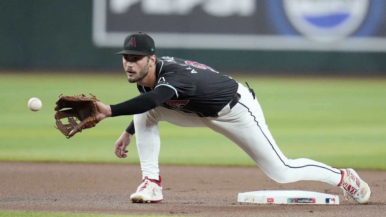 FILE - Arizona Diamondbacks second baseman Blaze Alexander warms up prior to a baseball game against the Colorado Rockies, Wednesday, Aug. 14, 2024, in Phoenix.