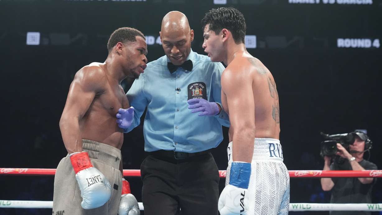 FILE - The referee talks to Devin Haney, left, and Ryan Garcia during the fourth round of a super lightweight boxing match Sunday, April 21, 2024, in New York.
