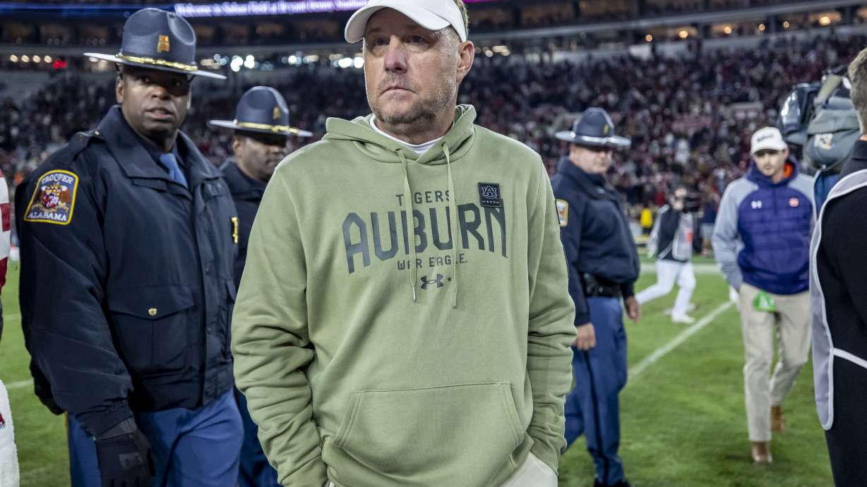 FILE - Auburn head coach Hugh Freeze, center, walks off the field after an NCAA college football game against Alabama, Saturday, Nov. 30, 2024, in Tuscaloosa, Ala.