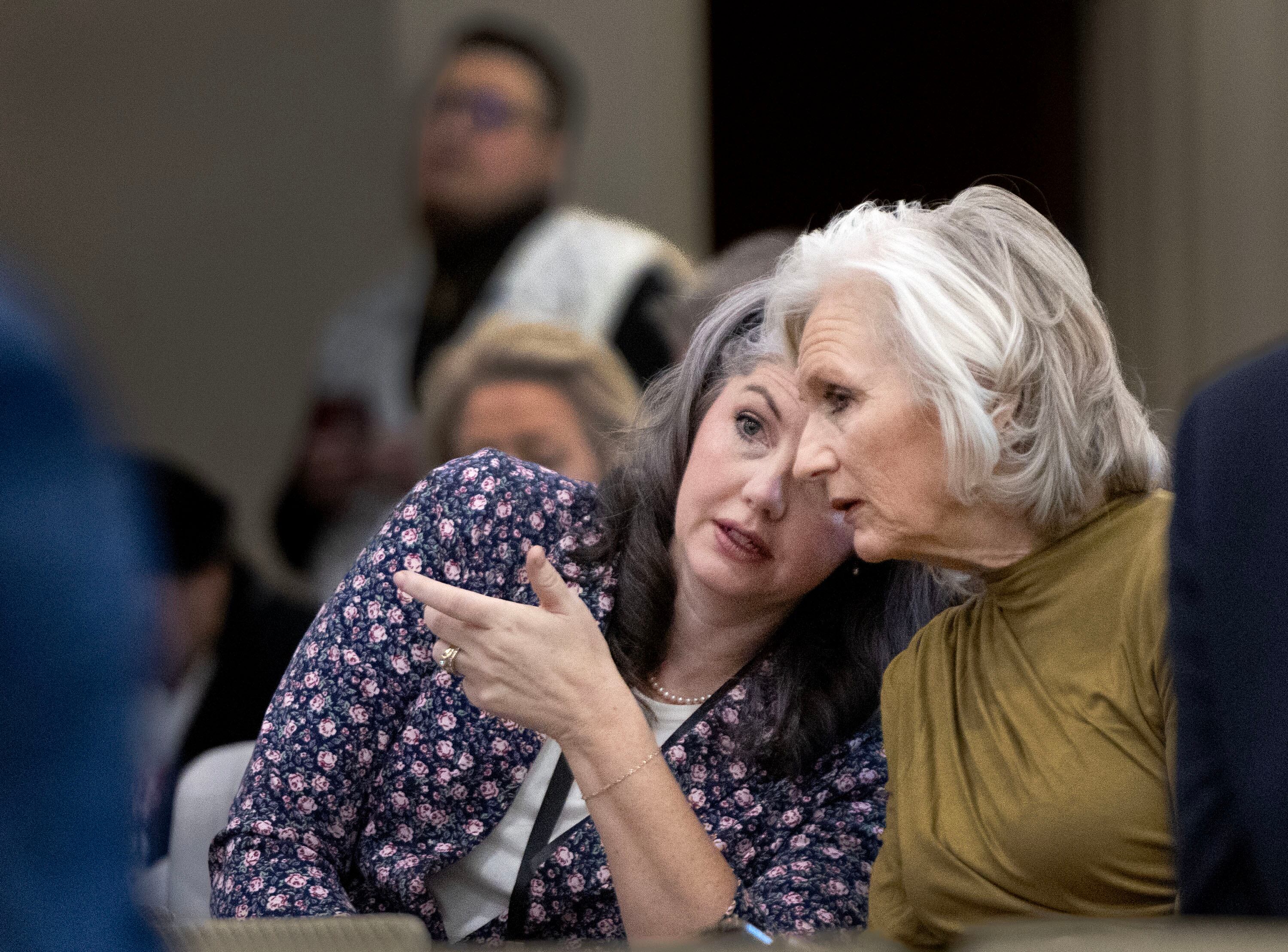 Corinne Johnson, president of Utah Parents United, left, and Dalane England, Utah Eagle Forum, confer as HB77, Flag Display Amendments, is discussed in a Senate Education Committee meeting at the Capitol in Salt Lake City on Friday.