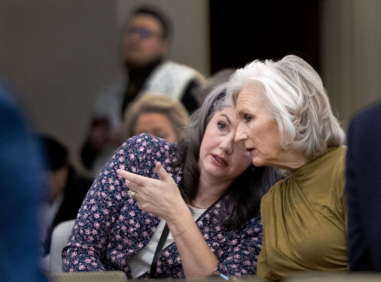 Corinne Johnson, president of Utah Parents United, left, and Dalane England, Utah Eagle Forum, confer as HB77, Flag Display Amendments, is discussed in a Senate Education Committee meeting at the Capitol in Salt Lake City on Friday.