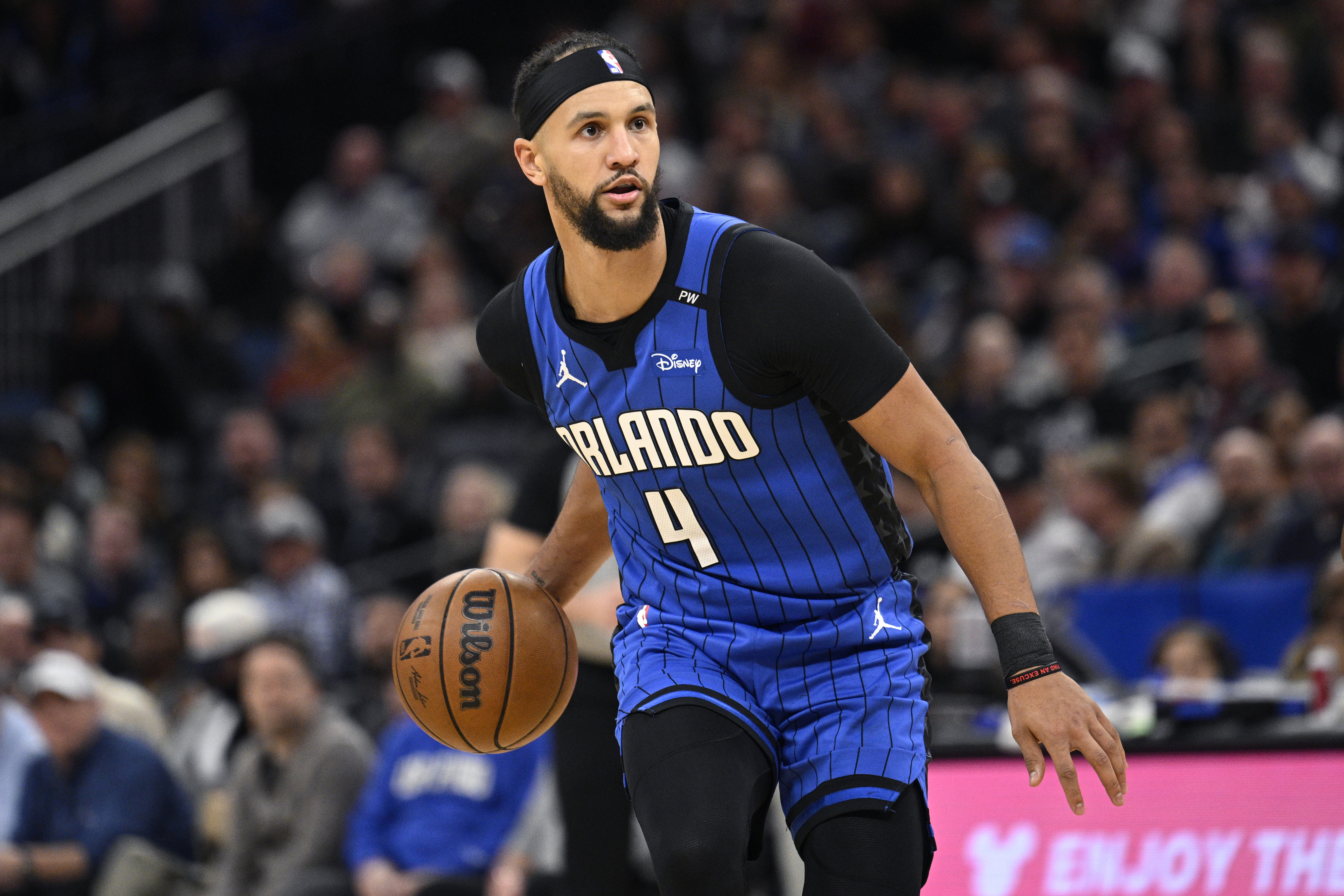 FILE - Orlando Magic guard Jalen Suggs (4) brings the ball up the court against the Detroit Pistons during the first half of an NBA basketball game, Jan. 25, 2025, in Orlando, Fla.