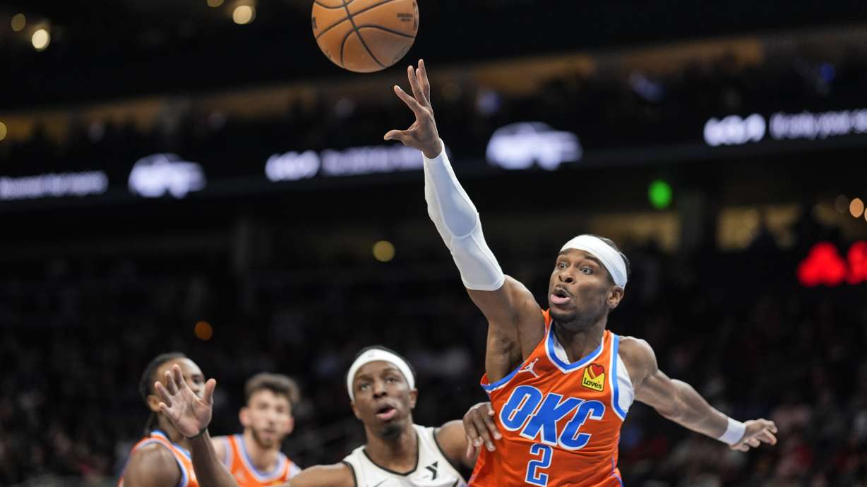 Oklahoma City Thunder guard Shai Gilgeous-Alexander (2) works against Atlanta Hawks forward Onyeka Okongwu (17) during the first half of an NBA basketball game, Friday, Feb. 28, 2025, in Atlanta.