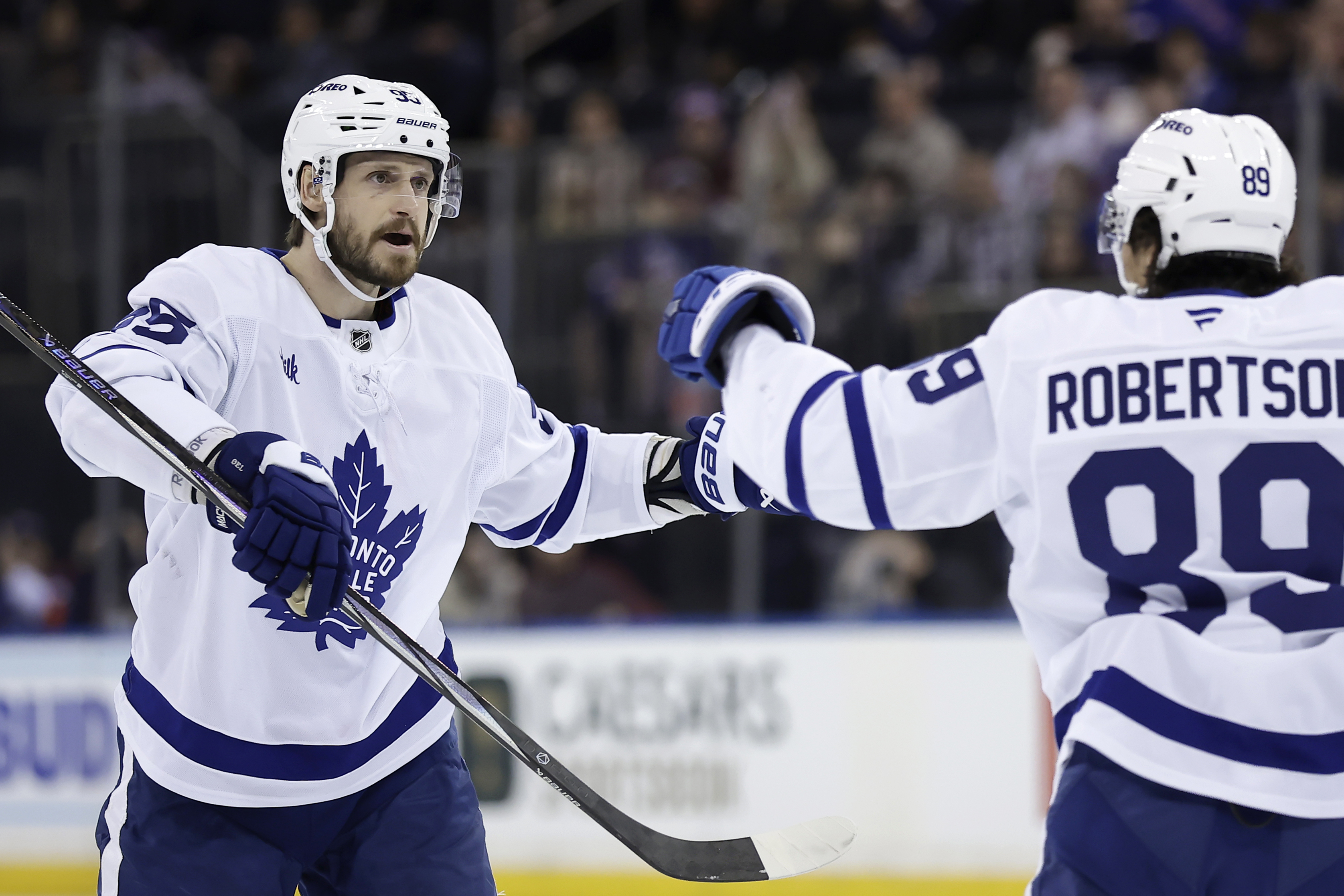 Toronto Maple Leafs defenseman Oliver Ekman-Larsson, left, is congratulated by Nicholas Robertson (89) after scoring in the first period of an NHL hockey game against the New York Rangers, Friday, Feb. 28, 2025, in New York. 