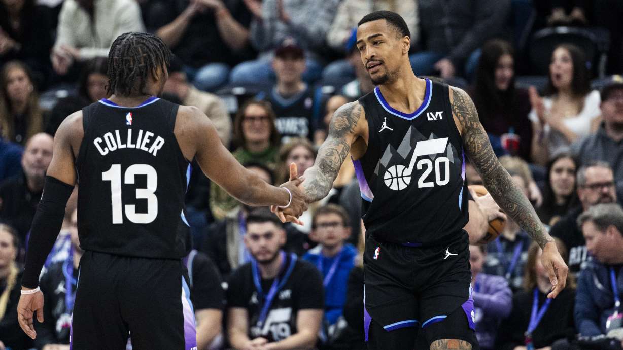 Utah Jazz forward John Collins (20) slaps hands with guard Isaiah Collier (13) after Collins made a basket and also earned a trip to the line after a Minnesota Timberwolves foul on his shot during an NBA basketball game against the Minnesota Timberwolves held at the Delta Center in Salt Lake City on Friday, Feb. 28, 2025.