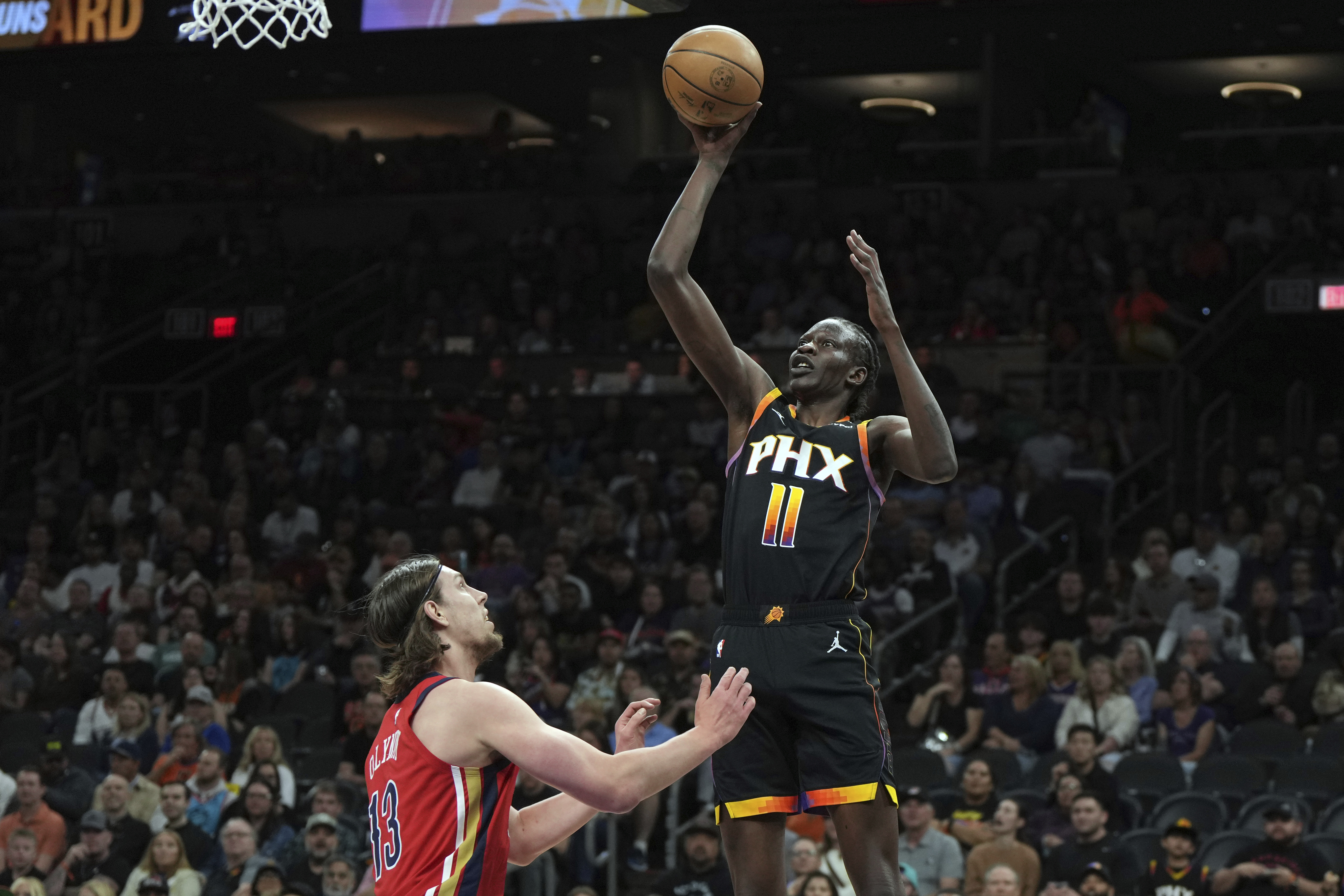 Phoenix Suns center Bol Bol (11) shoots over New Orleans Pelicans forward Kelly Olynyk during the first half of an NBA basketball game, Friday, Feb. 28, 2025, in Phoenix. 
