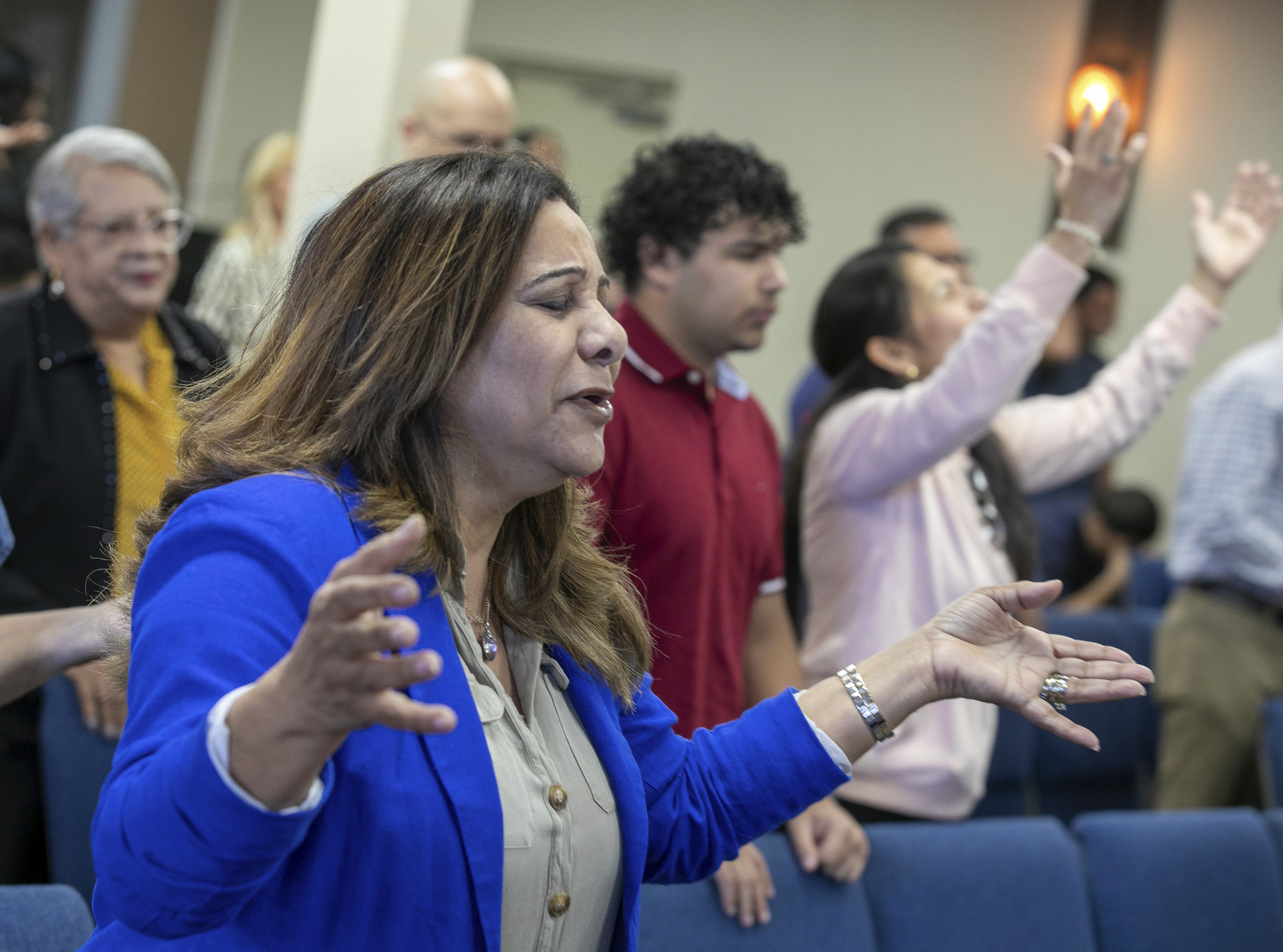 Fatima Guzman prays during a church service at the Centro Cristiano El Pan de Vida, a mid-size Church of God of Prophecy congregation in Kissimmee, Florida, Sunday, Feb. 2, 2025.