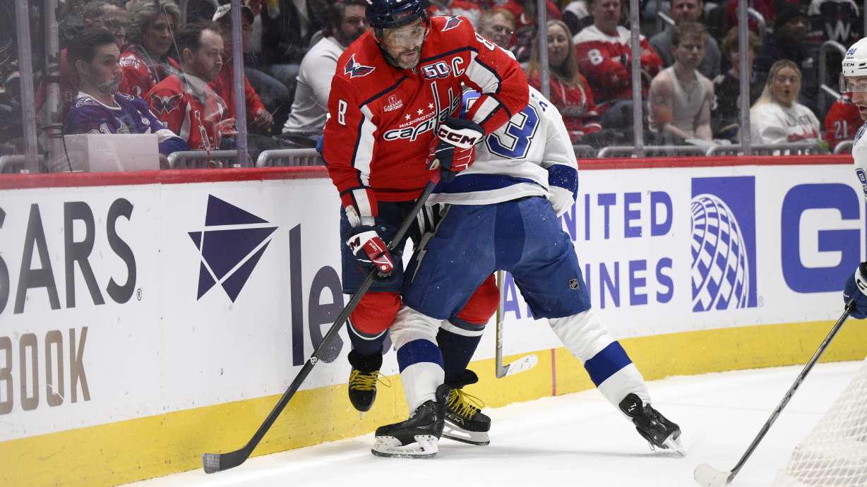 Washington Capitals left wing Alex Ovechkin (8) and Tampa Bay Lightning center Gage Goncalves, right, battle along the boards during the first period of an NHL hockey game, Saturday, March 1, 2025, in Washington.