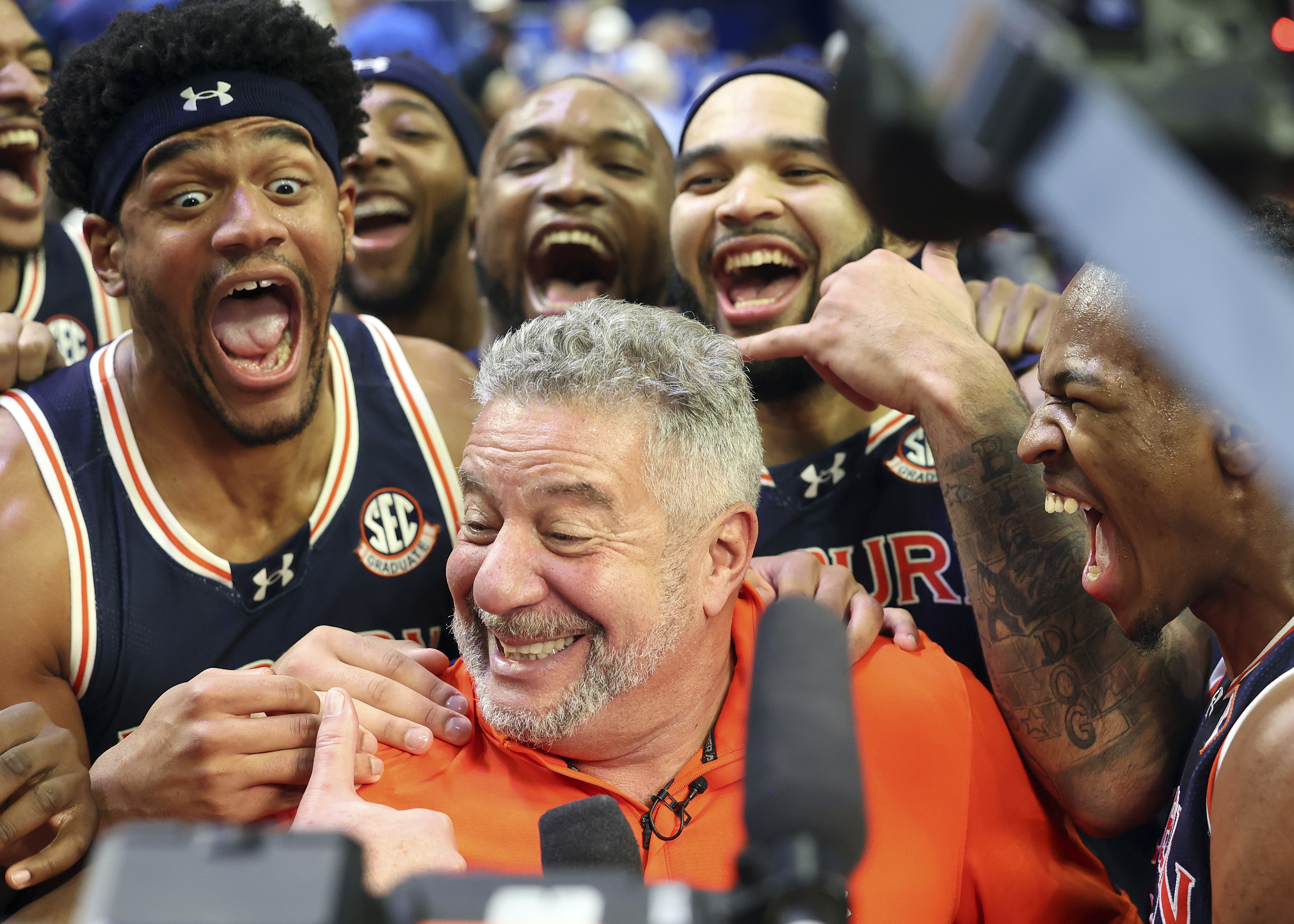 Auburn head coach Bruce Pearl, center, celebrates with his team after defeating Kentucky in an NCAA college basketball game in Lexington, Ky., Saturday, March 1, 2025. 