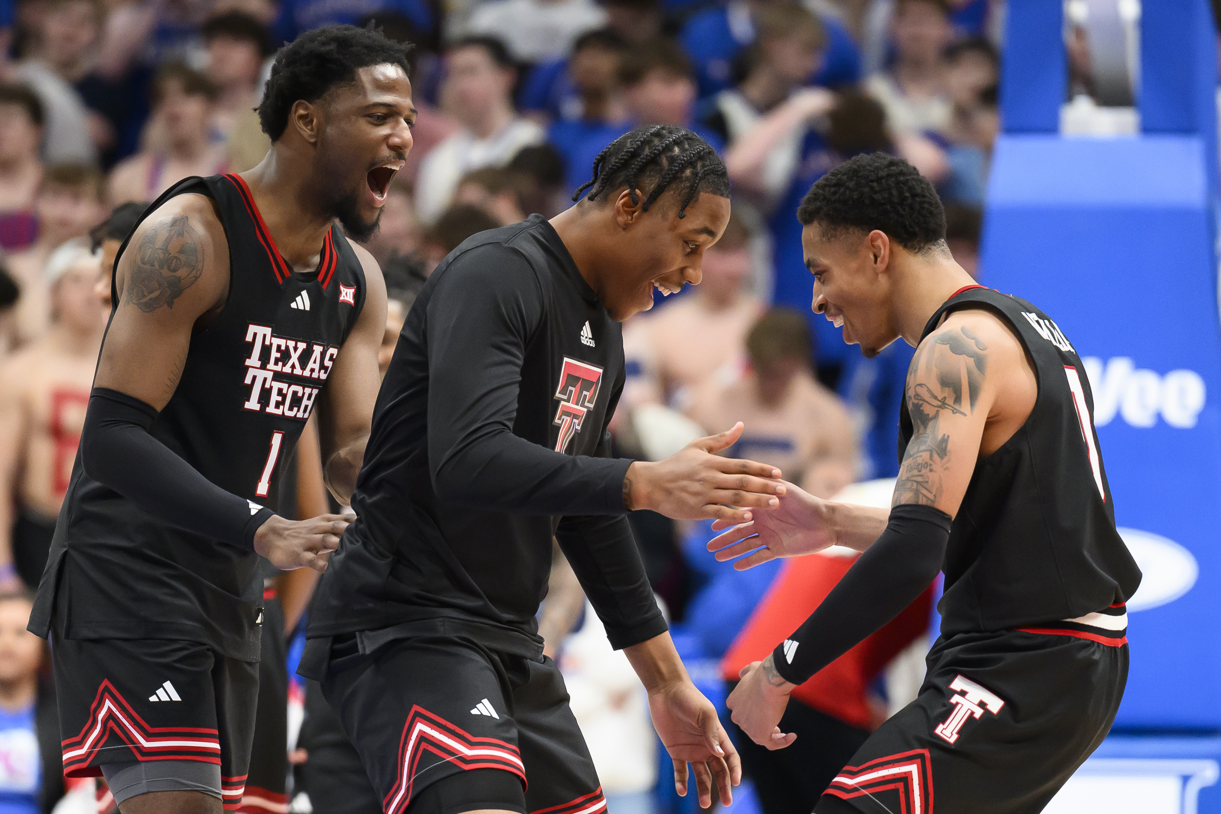 Texas Tech guard Chance McMillian, right celebrates with teammates, including guard Kevin Overton (1) after they defeated Kansas in an NCAA college basketball game in Lawrence, Kan., Saturday, March 1, 2025. 