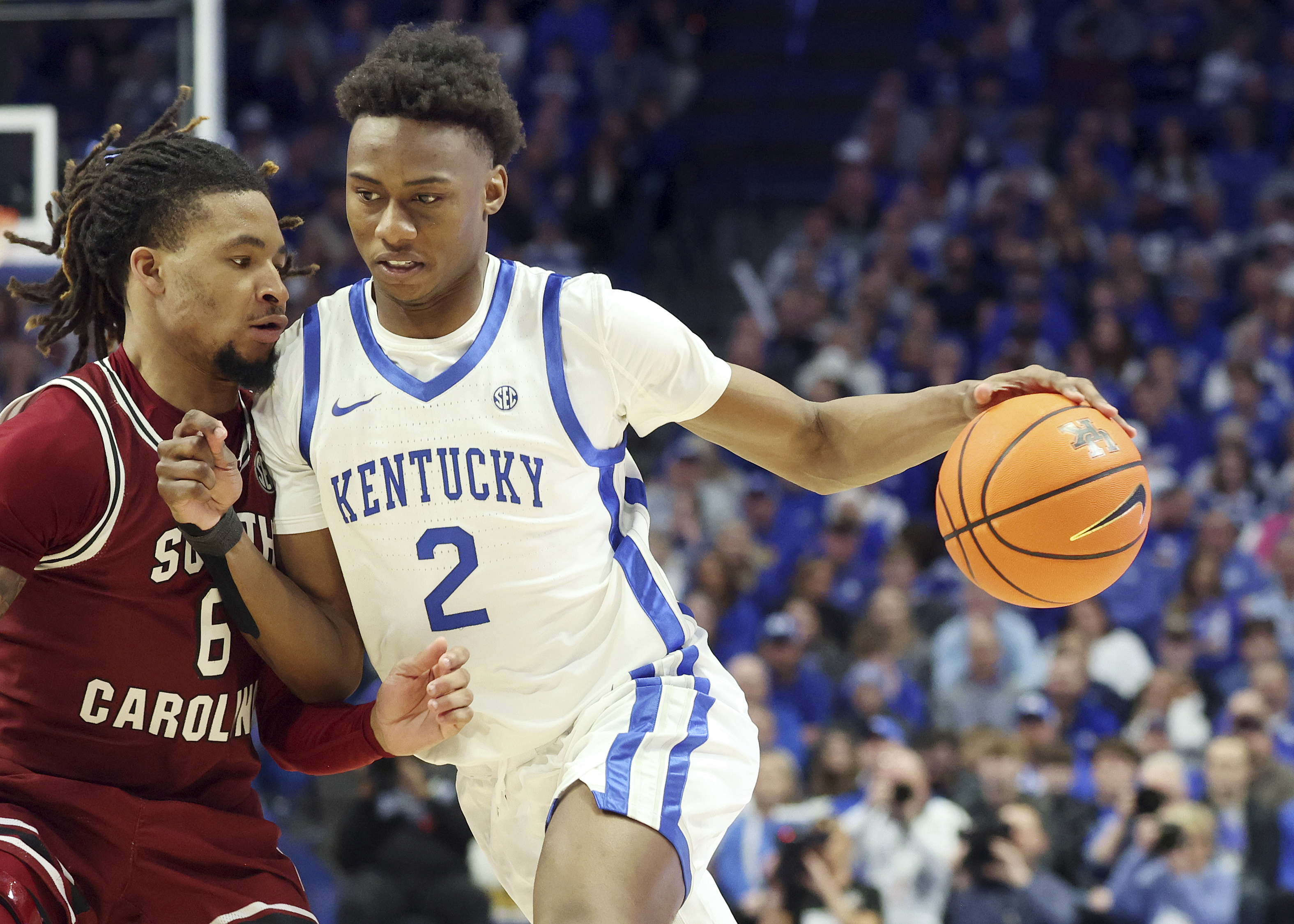 Kentucky's Jaxson Robinson (2) drives into South Carolina's Jamarii Thomas (6) during the second half of an NCAA college basketball game in Lexington, Ky., Saturday, Feb. 8, 2025. 