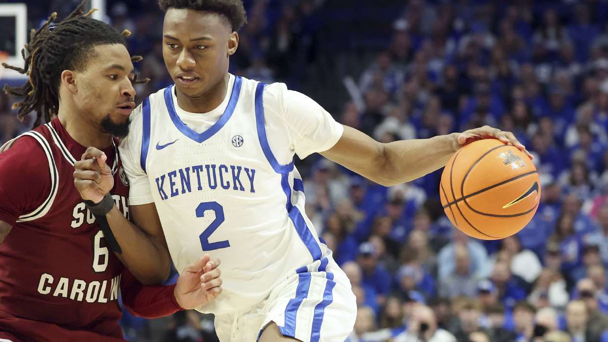 Kentucky's Jaxson Robinson (2) drives into South Carolina's Jamarii Thomas (6) during the second half of an NCAA college basketball game in Lexington, Ky., Saturday, Feb. 8, 2025.
