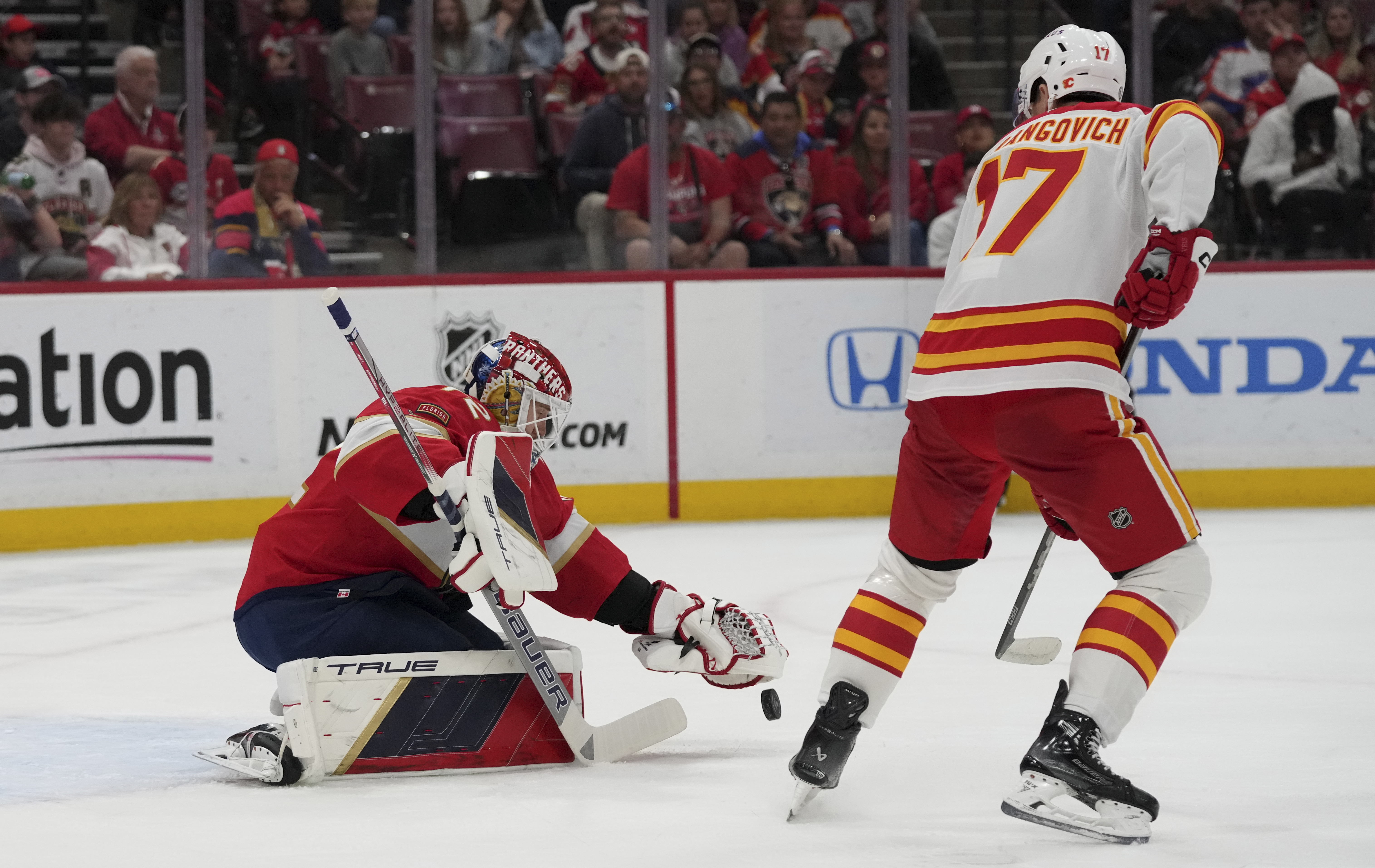 Florida Panthers goaltender Sergei Bobrovsky (72) defends the goal against Calgary Flames center Yegor Sharangovich (17) during the first period of an NHL hockey game, Saturday, March 1, 2025, in Sunrise, Fla. 