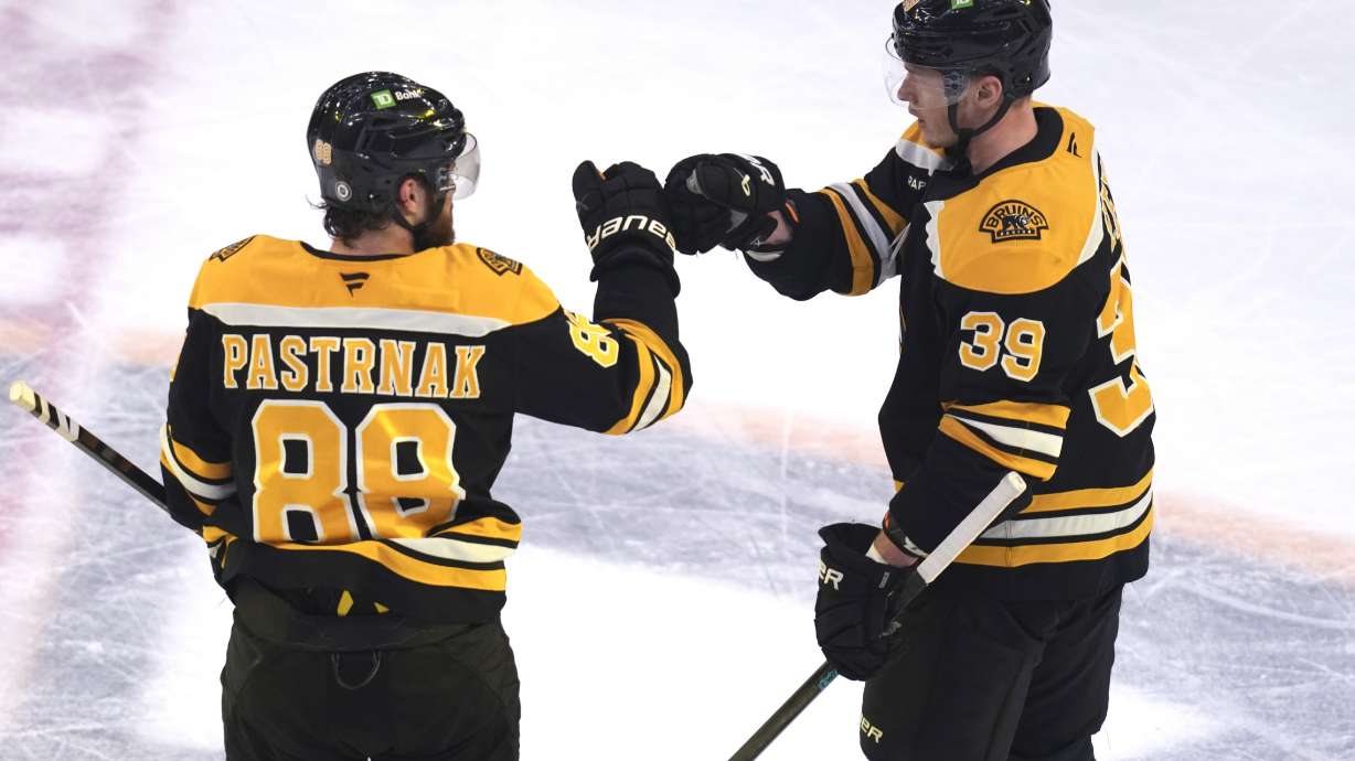 Boston Bruins center Morgan Geekie (39) is congratulated by David Pastrnak (88) after his goal against the Minnesota Wild during the third period of an NHL hockey game, Tuesday, Feb. 4, 2025, in Boston.
