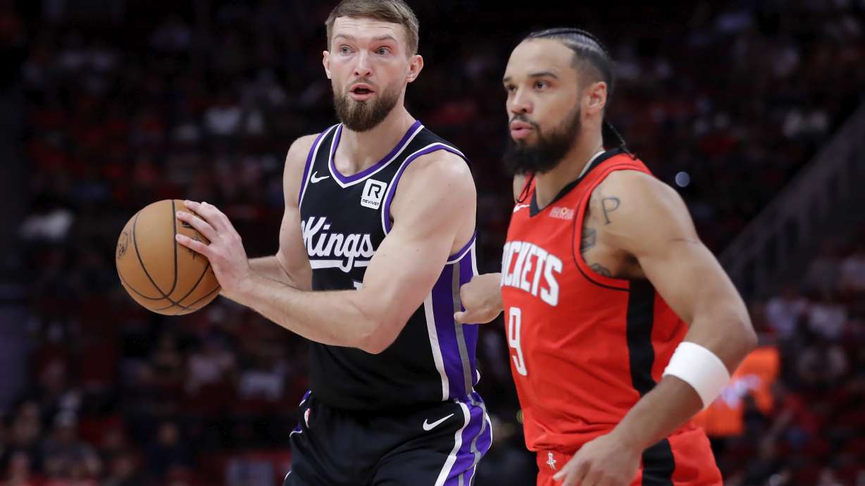 Sacramento Kings forward Domantas Sabonis, looks to pass the ball next to Houston Rockets forward Dillon Brooks, right, during the first half of an NBA basketball game, Saturday, March 1, 2025, in Houston.