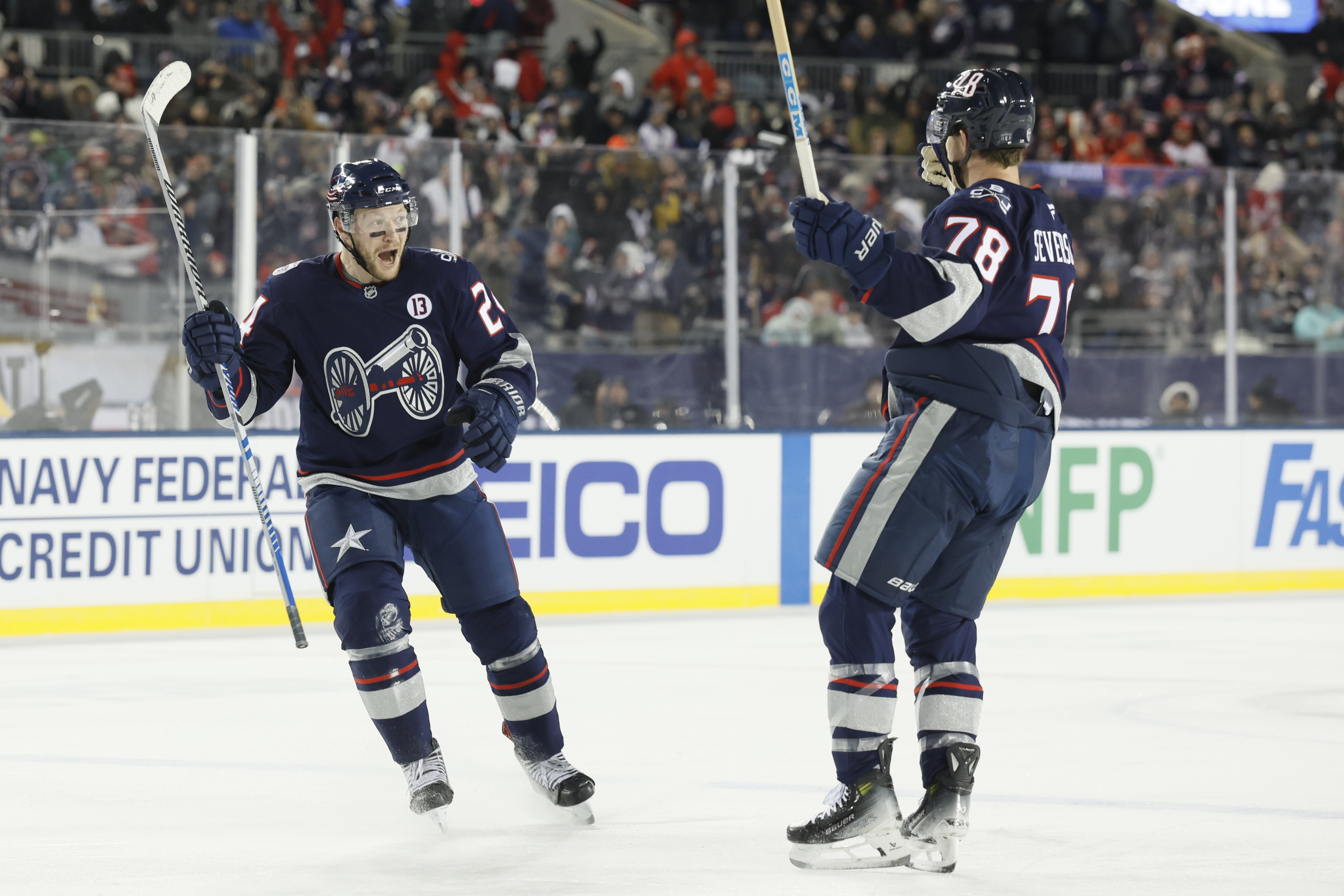 Columbus Blue Jackets' Mathieu Olivier, left, celebrates his goal against the Detroit Red Wings with teammate Damon Severson during the second period of the Stadium Series NHL hockey game at Ohio Stadium Saturday, March 1, 2025, in Columbus, Ohio. 