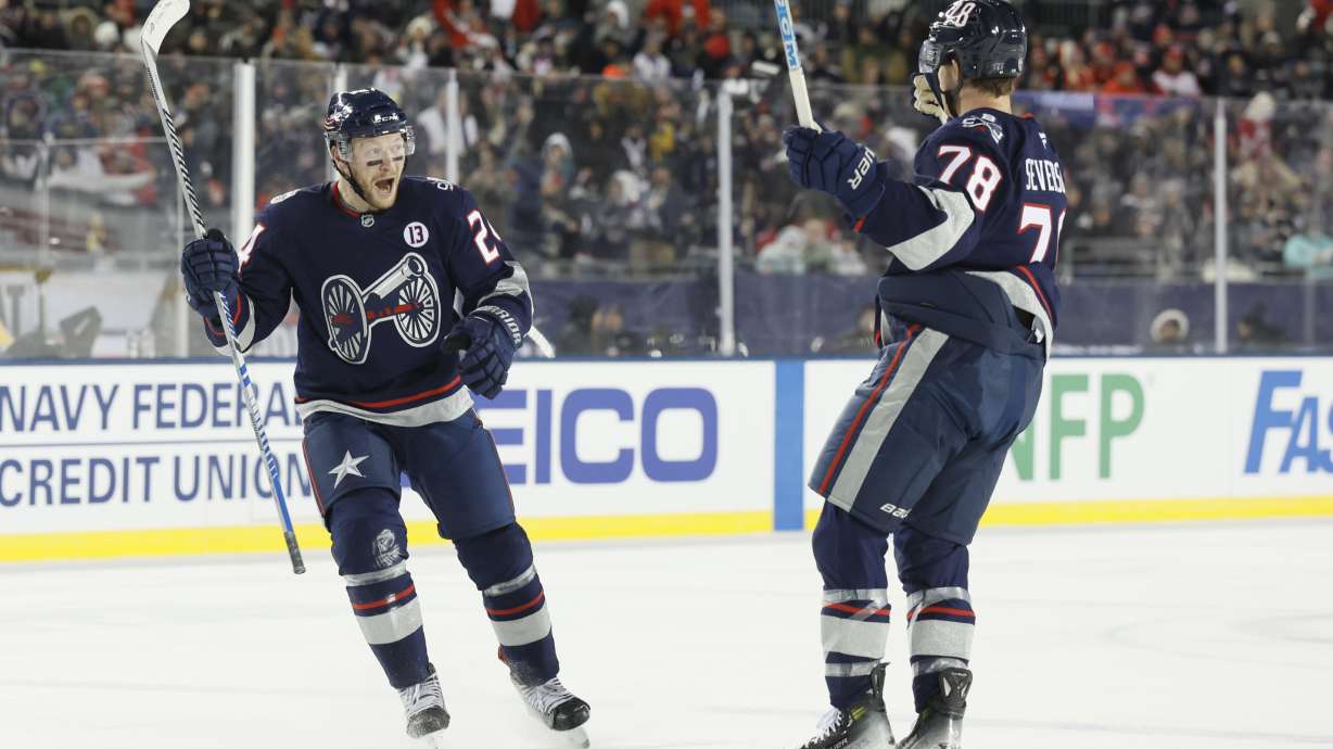Columbus Blue Jackets' Mathieu Olivier, left, celebrates his goal against the Detroit Red Wings with teammate Damon Severson during the second period of the Stadium Series NHL hockey game at Ohio Stadium Saturday, March 1, 2025, in Columbus, Ohio.