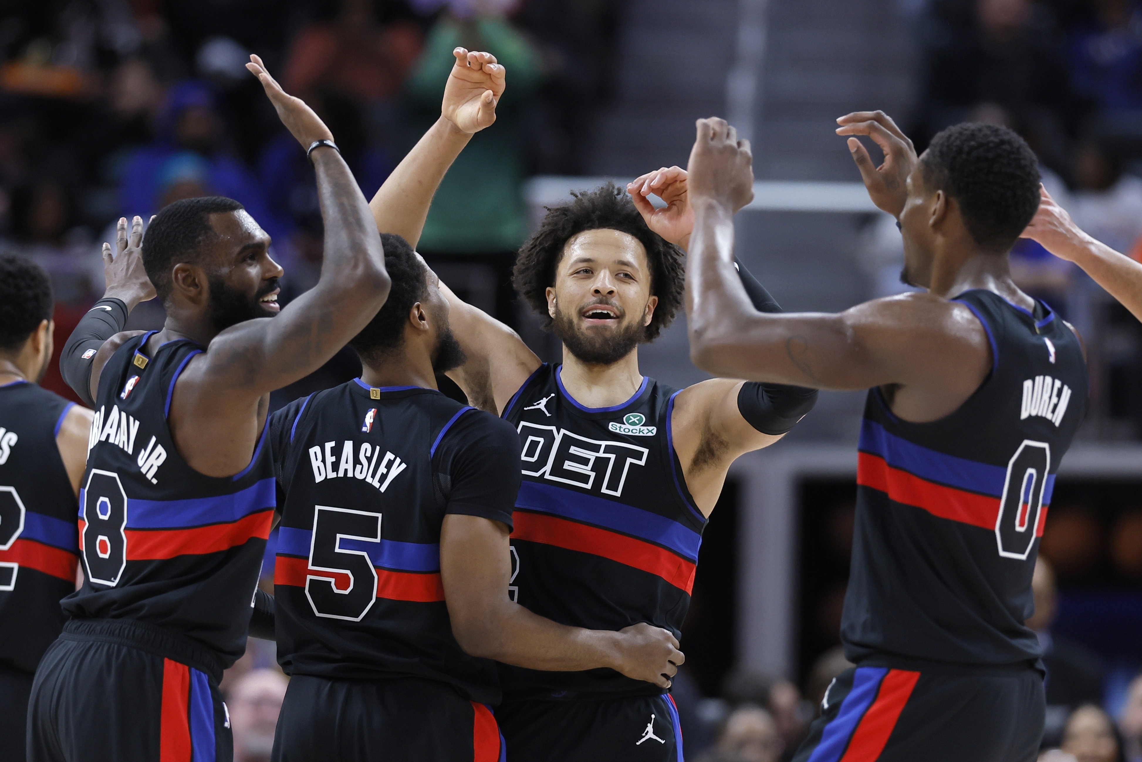 Detroit Pistons guard Cade Cunningham, second from right, celebrates with forward Tim Hardaway Jr. (8), guard Malik Beasley (5) and center Jalen Duren (0) during the first half of an NBA basketball game against the Brooklyn Nets, Saturday, March 1, 2025, in Detroit. 