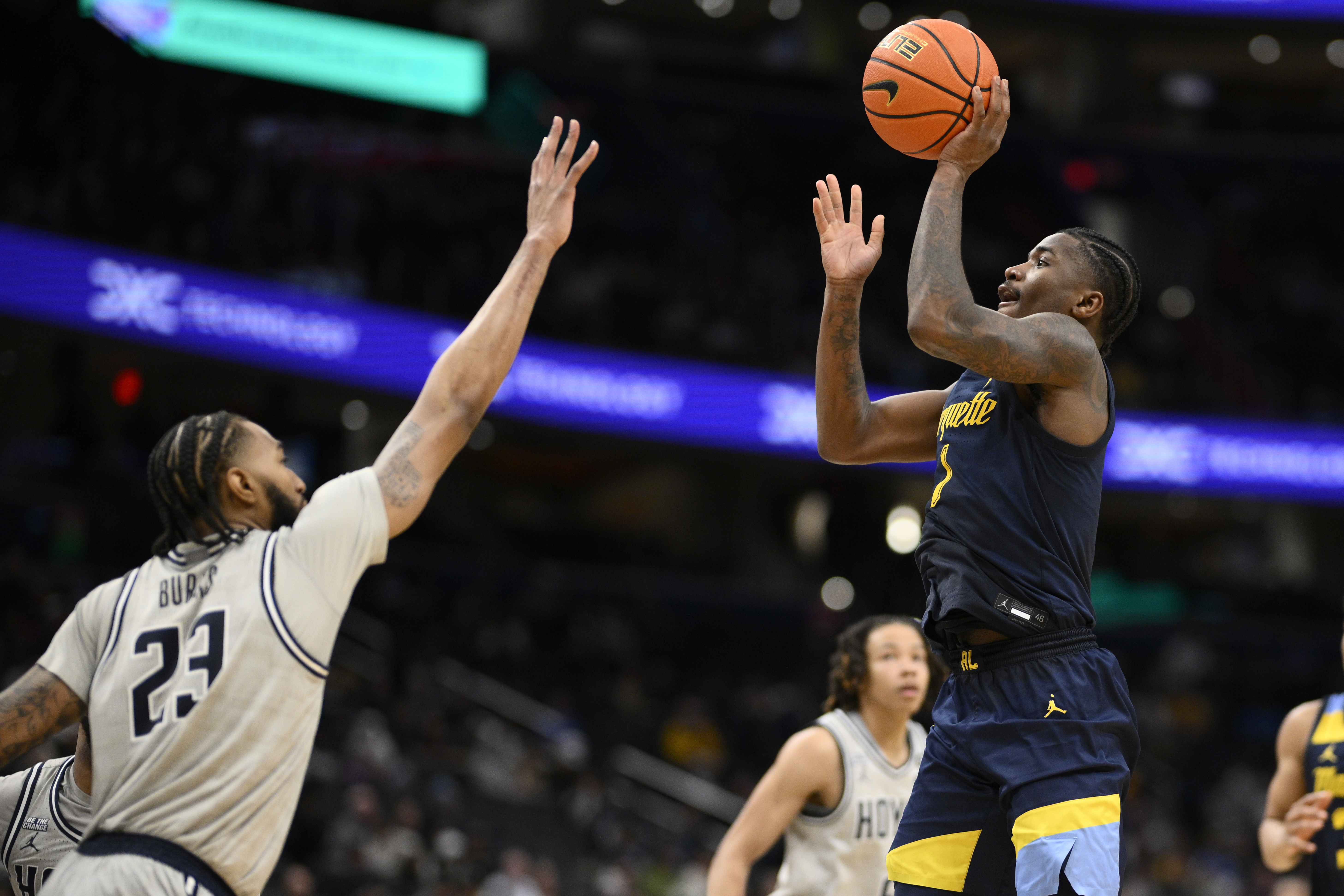 Marquette guard Kam Jones shoots against Georgetown forward Jordan Burks (23) during the second half of an NCAA college basketball game, Saturday, March 1, 2025, in Washington. 