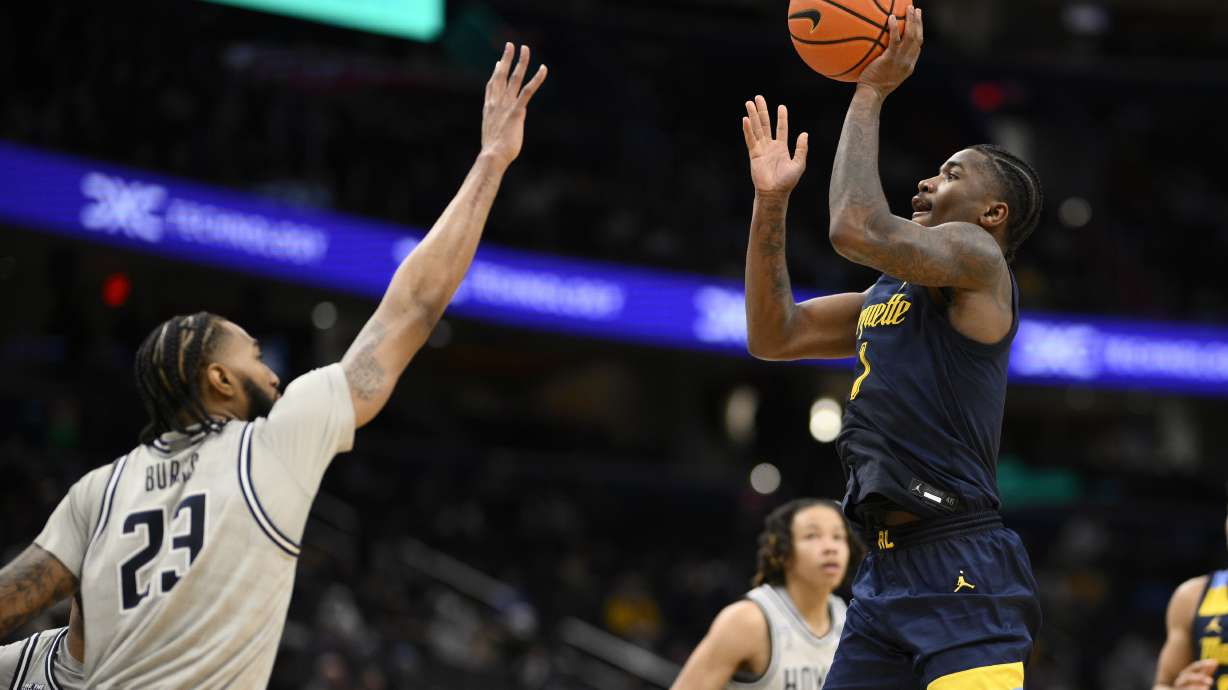 Marquette guard Kam Jones shoots against Georgetown forward Jordan Burks (23) during the second half of an NCAA college basketball game, Saturday, March 1, 2025, in Washington.