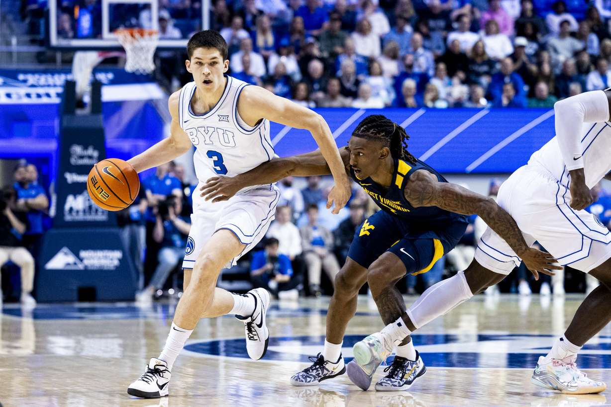 BYU guard Egor Demin (3) is guarded by West Virginia Mountaineers guard Javon Small (7) as Demin drives the ball around a screen set by center Keba Keita (13) during an NCAA men’s basketball game held at the Marriott Center in Provo on Saturday, March 1, 2025.