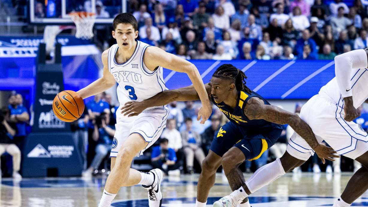 BYU guard Egor Demin (3) is guarded by West Virginia Mountaineers guard Javon Small (7) as Demin drives the ball around a screen set by center Keba Keita (13) during an NCAA men’s basketball game held at the Marriott Center in Provo on Saturday, March 1, 2025.