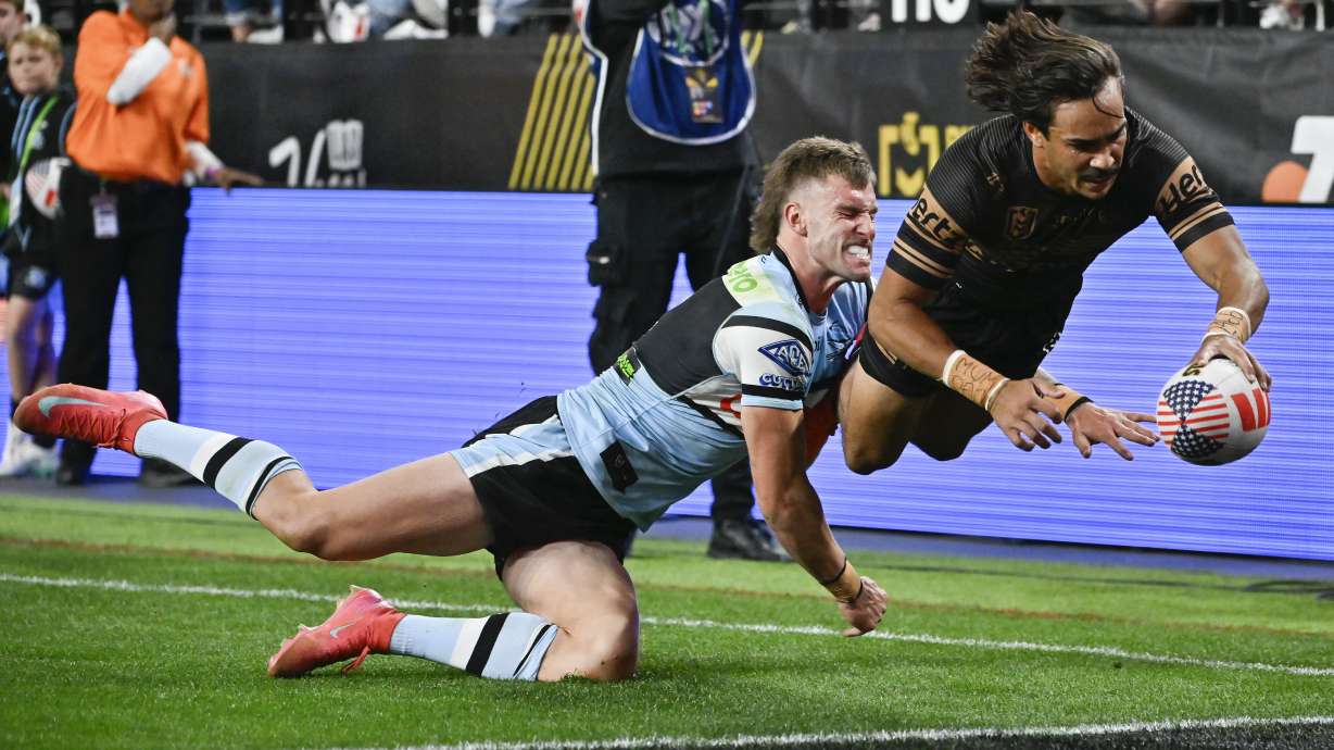 Penrith Panthers Daine Laurie dives across the line to score a try during Australia's National Rugby League game between the Penrith Panthers and Cronulla Sutherland-Sharks at Allegiant Stadium in Las Vegas, Saturday, March 1, 2025.