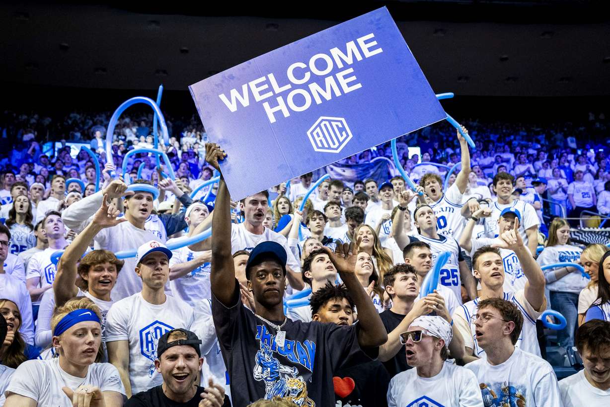 AJ Dybantsa, the nation's No. 1 basketball recruit who has committed to BYU, holds a sign with students at halftime during an NCAA men’s basketball game against the West Virginia Mountaineers held at the Marriott Center in Provo on Saturday, March 1, 2025.